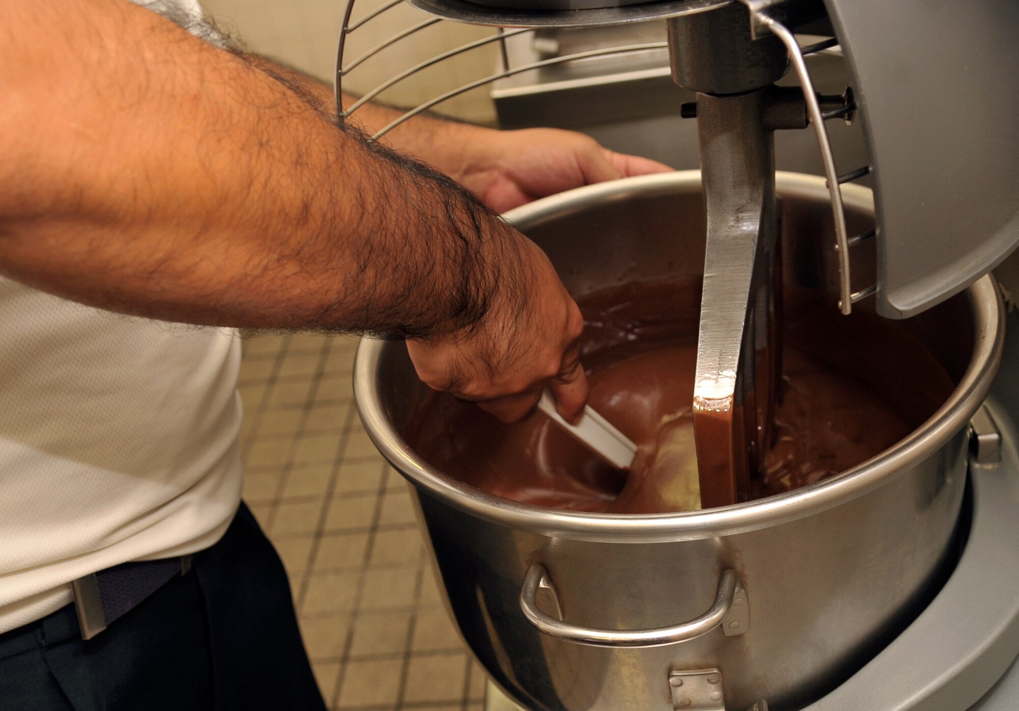 Narihiro Nakamoto, 18th Force Support Squadron baker, mixes chocolate cream for dessert at the Marshall Dining Facility on Kadena Air Base, Japan, Oct. 17, 2013. More than 50 civilian contractors and 26 military service members cook and serve food for military members and U.S. civilian contractors. (U.S. Air Force photo by Naoto Anazawa)