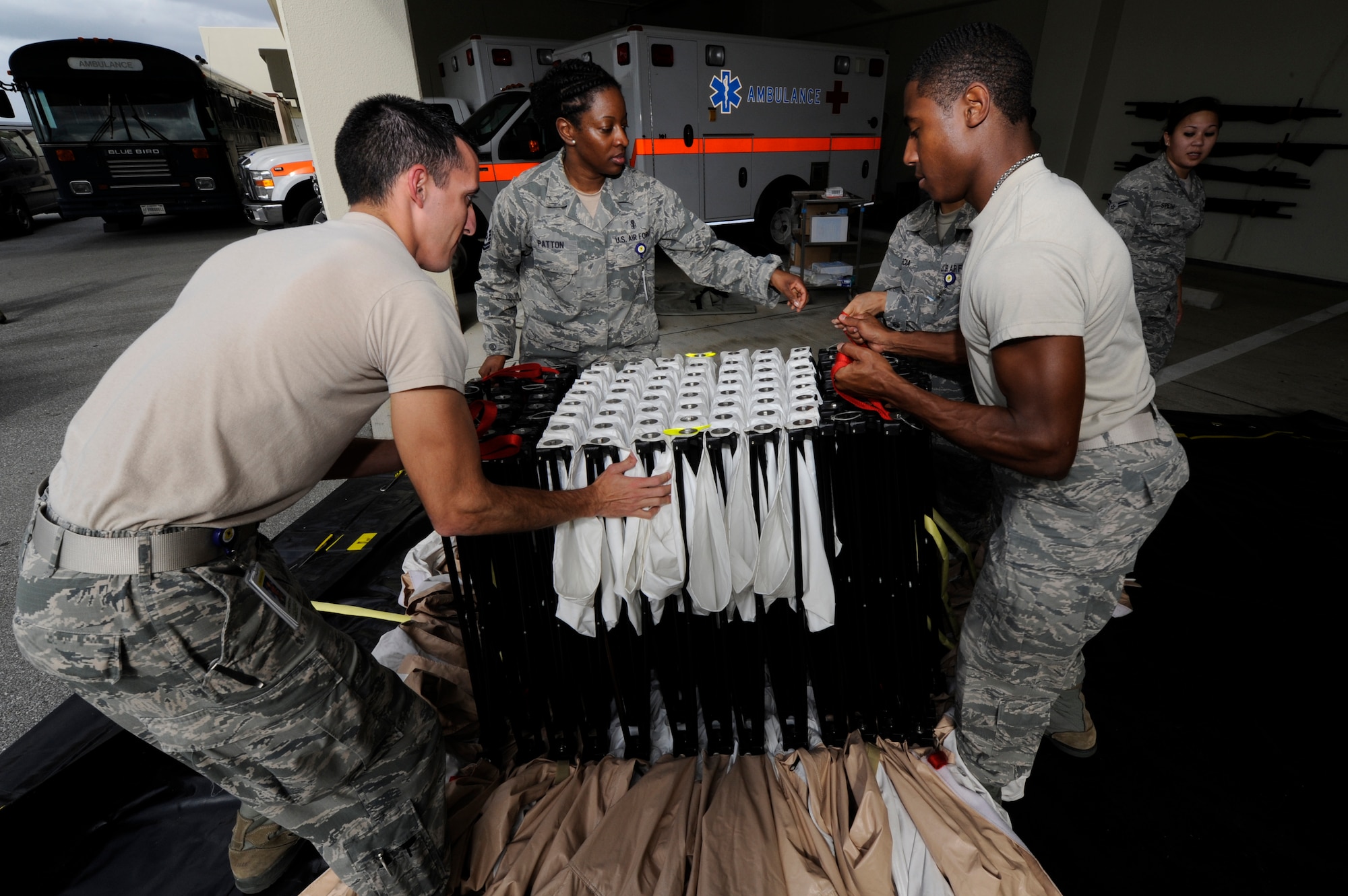 Airmen from the 18th Medical Group disassemble a decontamination tent during a medical training day at Kadena Air Base, Japan, Oct. 17, 2013. The Airmen must be able to quickly set up the tent to treat contaminated patients after a chemical attack. (U.S. Air Force photo by Senior Airman Marcus Morris)