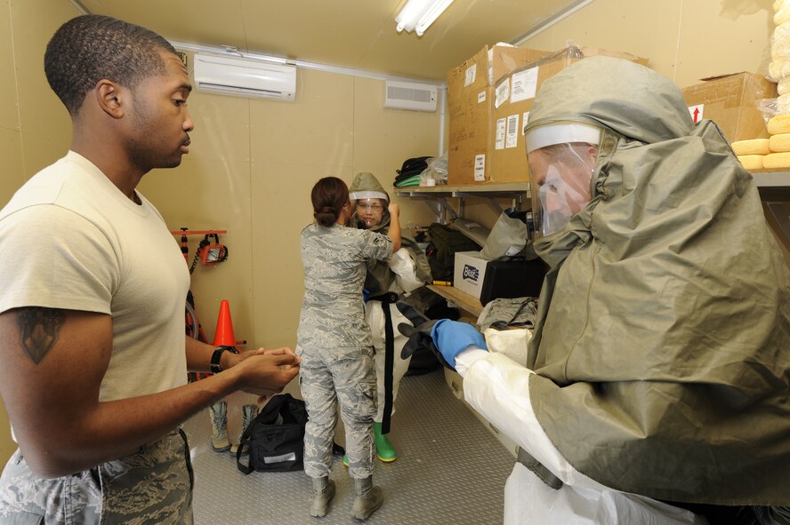 Airmen from the 18th Medical Group train on properly wearing decontamination suits at Kadena Air Base, Japan, Oct. 17, 2013. The suits allow the Airmen to decontaminate patients without contaminating themselves. (U.S. Air Force photo by Senior Airman Marcus Morris) 