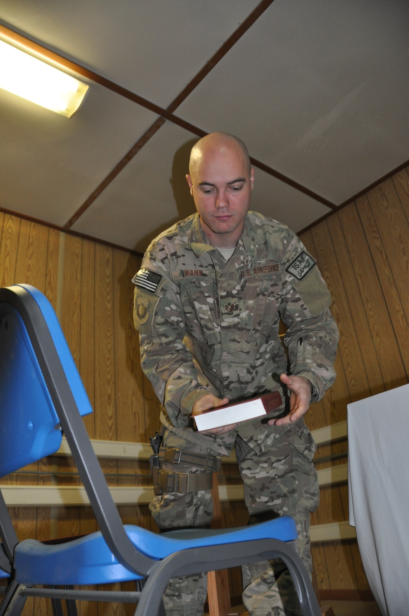 Staff Sgt. Lowell Wann, 455th Air Expeditionary Wing chaplain assistant, deployed from Buckley Air Force Base, Colo., and a native of Odessa, Mo., prepares the Bagram Airfield flightline chapel before a non-denominational Christian worship service at Bagram Airfield, Afghanistan, Oct. 16, 2013. (U.S. Air Force photo/Tech. Sgt. Rob Hazelett)