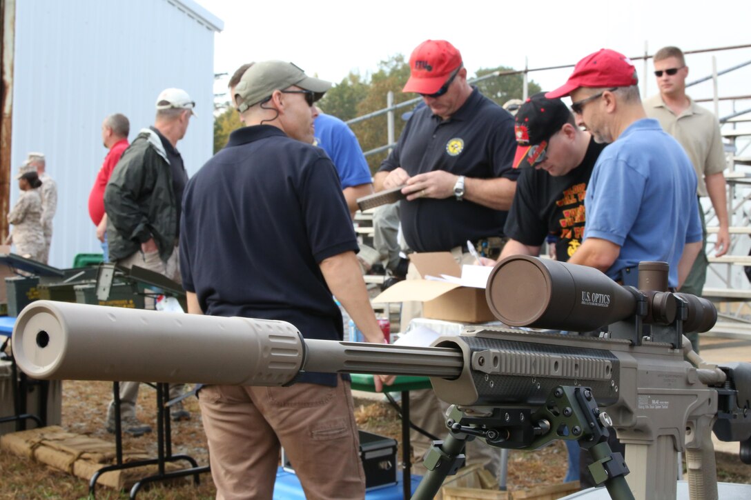Participants sign paperwork before shooting weapons at Range 7 aboard Marine Corps Base Quantico during an event with the Wounded Warrior Regiment on Oct. 17, 2013. The FBI hosted the event which gave the Marines an opportunity to fire more than two dozen weapons.  