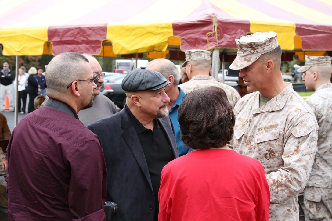 Col. Glenn Guenther, commanding officer, Weapons Training Battalion, greets family members of the late Master Sgt. Adam Benjamin at Benjamin Hall aboard Marine Corps Base Quantico on Oct. 17, 2013. The family was aboard base participating in the dedication ceremony of a new barracks building named after Benjamin.