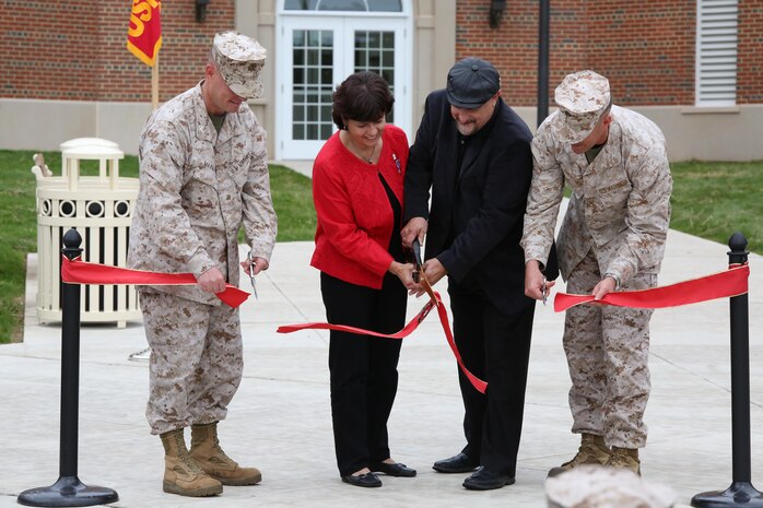From the left, Col. David Maxwell, commanding officer of Marine Corps Base Quantico; family members of the late Master Sgt. Adam Benjamin; and Col. Glenn Guenther, commanding officer, Weapons Training Battalion; cut a ribbon during a dedication ceremony of Benjamin Hall, a new barracks building, aboard Marine Corps Base Quantico on Oct. 17, 2013. The new barracks was named after Benjamin who was killed while serving in Afghanistan in 2009.