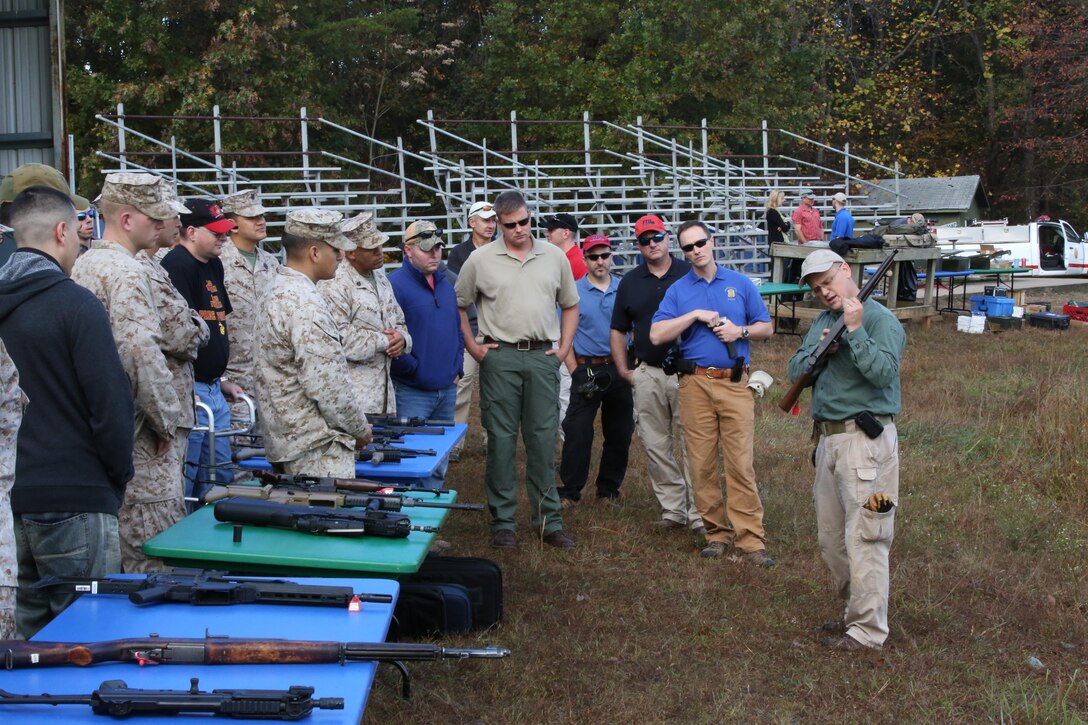 An FBI employee explains how a weapon works during a Wounded Warrior event at Range 7 aboard Marine Corps Base Quantico on Oct. 17. 2013. More than 30 people participated in the event.