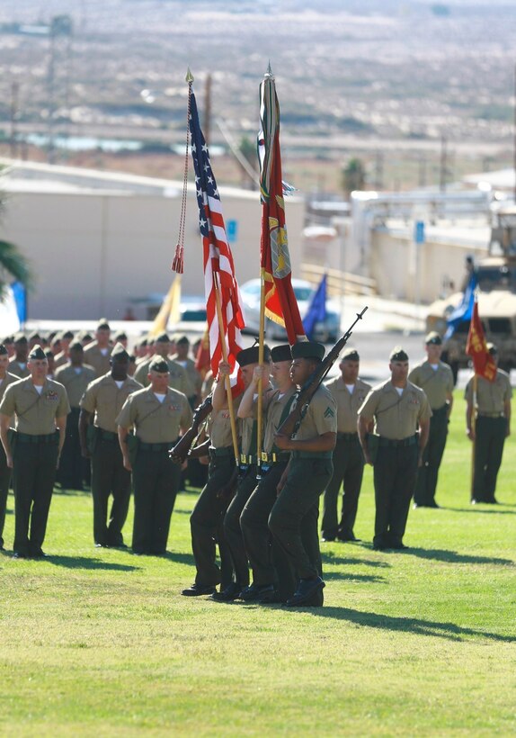 The 7th Marine Regiment color guard marches onto the field during a change of command ceremony at the Lance Cpl. Torrey L. Gray Memorial Field here, Oct. 17, 2013. Colonel Austin E. Renforth, relinquished command of the regiment to Col. Jay M. Bargeron.