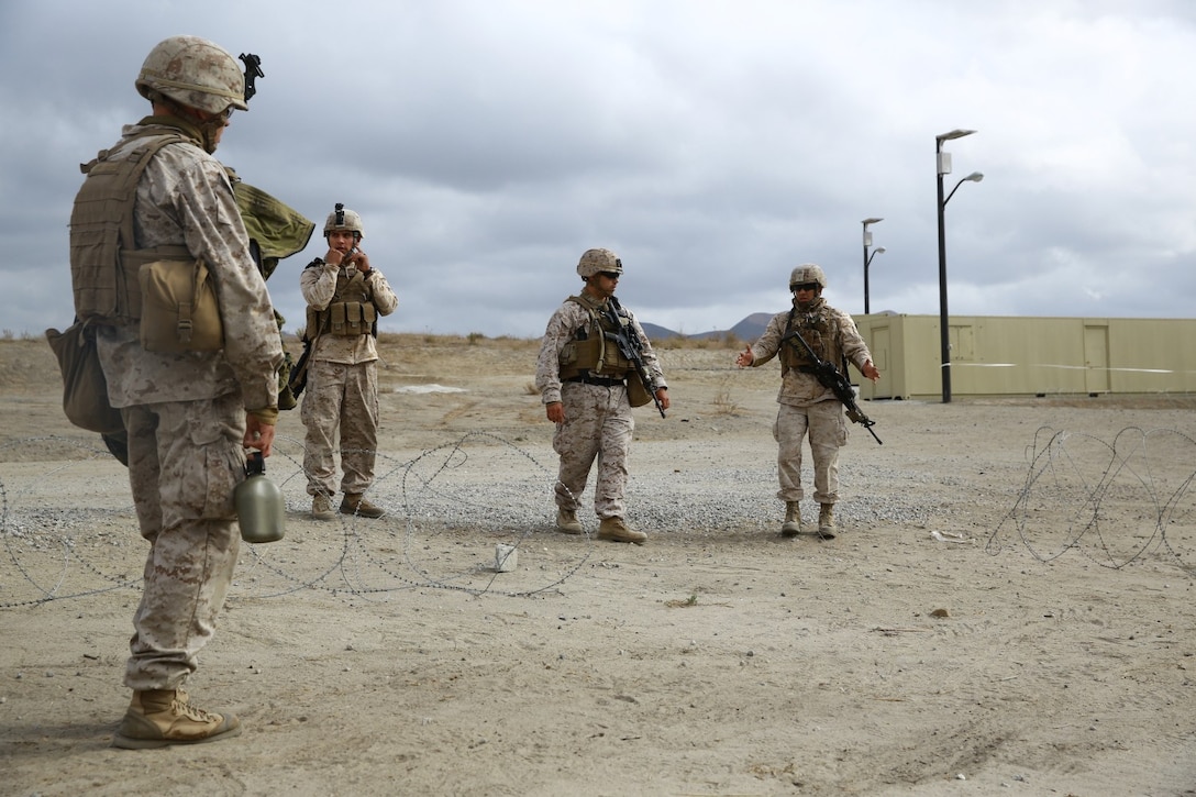 Marines serving with 1st Battalion, 1st Marine Regiment, deploy concertina while conducting site security training here, Oct. 9, 2013. The training gave Marines a chance to refine their skills in setting up and maintaining a fortified position. The training was designed to prepare the Marines for their upcoming deployment to the Middle East where they will provide embassy security.