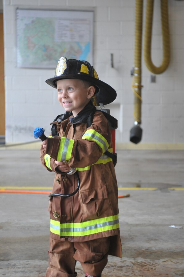 Tommy, 3 plays with a pump hose while at Fire Station 533 on Oct. 10, 2013. TJ, who has a rare blood disorder, Langer cell histiocytosis, fell in love with firefighters while he was in the hospital. TJ is a 3-year-old who has Langerhan cell histiocytosis. 
