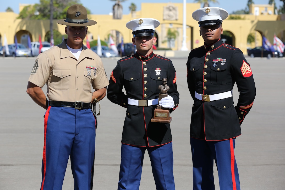 Pfc. Jesse Thomas, honor graduate for Charlie Company, and a Stockton, Calif., native stands with recruiter Sgt. Rueben Smith (right) and senior drill instructor Staff Sgt. Scott Henrysmon (left) after graduation aboard Marine Corps Recruit Depot San Diego, Oct. 18.  Thomas was chosen for company honor graduate because of his leadership skills, 1st class physical fitness test, 1st class combat fitness test and expert rifle score.