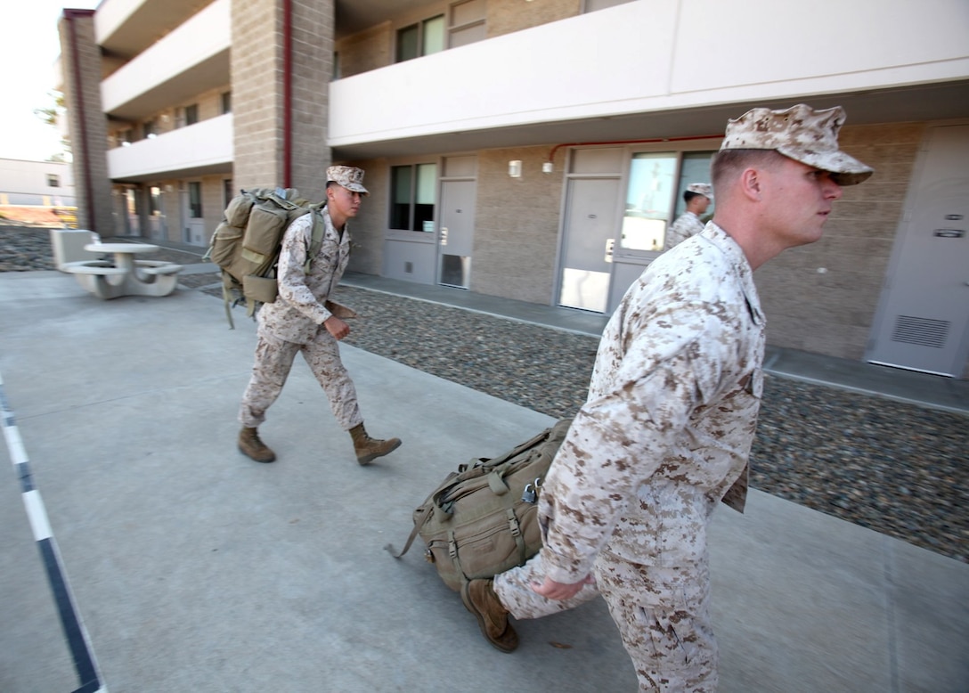 Marines with 1st Air Naval Gunfire Liaison Company move baggage for their returning peers during a homecoming aboard Camp Pendleton, Calif., Oct. 18. The returning Marines with Supporting Arms Liaison Team 8, worked directly with the Georgian Armed Forces to provide fire support assistance during combat operations in Afghanistan during their seven-month deployment.