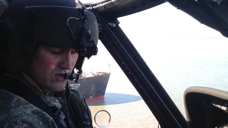 Capt. Robert Weakland pilots a Sikorsky UH-60 Blackhawk helicopter May 29 while scouting the U.S. Army Corps of Engineers’ hopper dredge, the Essayons, while it worked in the Cook Inlet Navigation Channel during the summer. Weakland and Maj. Eric Marcellus are both civil engineers for the Alaska District and serve as aviators in the Alaska Army National Guard’s 1st Battalion, 207th Aviation Regiment. 