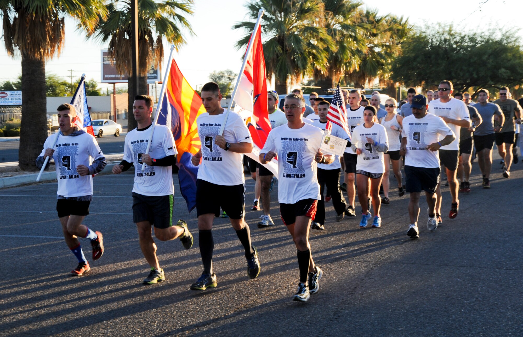 A flag-bearing relay team of 20 active-duty service members start to run the Arizona Run for the Fallen event at Freedom Park in Tucson, Ariz., Oct. 18, 2013. Each mile of the run was dedicated to fallen service members from Arizona who died during Operation Iraqi Freedom, Operation Enduring Freedom or Operation New Dawn. (U.S. Air Force photo by Senior Airman Sivan Veazie/Released)