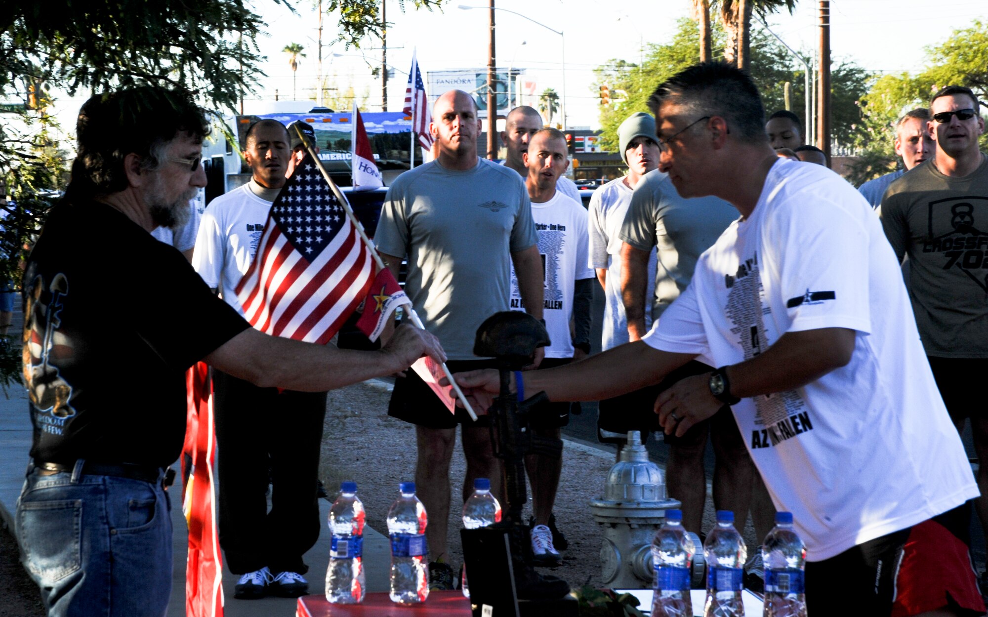 U.S. Army Specialist Lance Clarks' parents accept a hero marker from a participant during the Arizona Run for the Fallen event in Tucson, Ariz., Oct. 18, 2013. Participants ran more than 140 miles to honor the memory of the fallen service members from Arizona who died during Operation Iraqi Freedom, Operation Enduring Freedom or Operation New Dawn and their families. (U.S. Air Force photo by Senior Airman Sivan Veazie/Released)