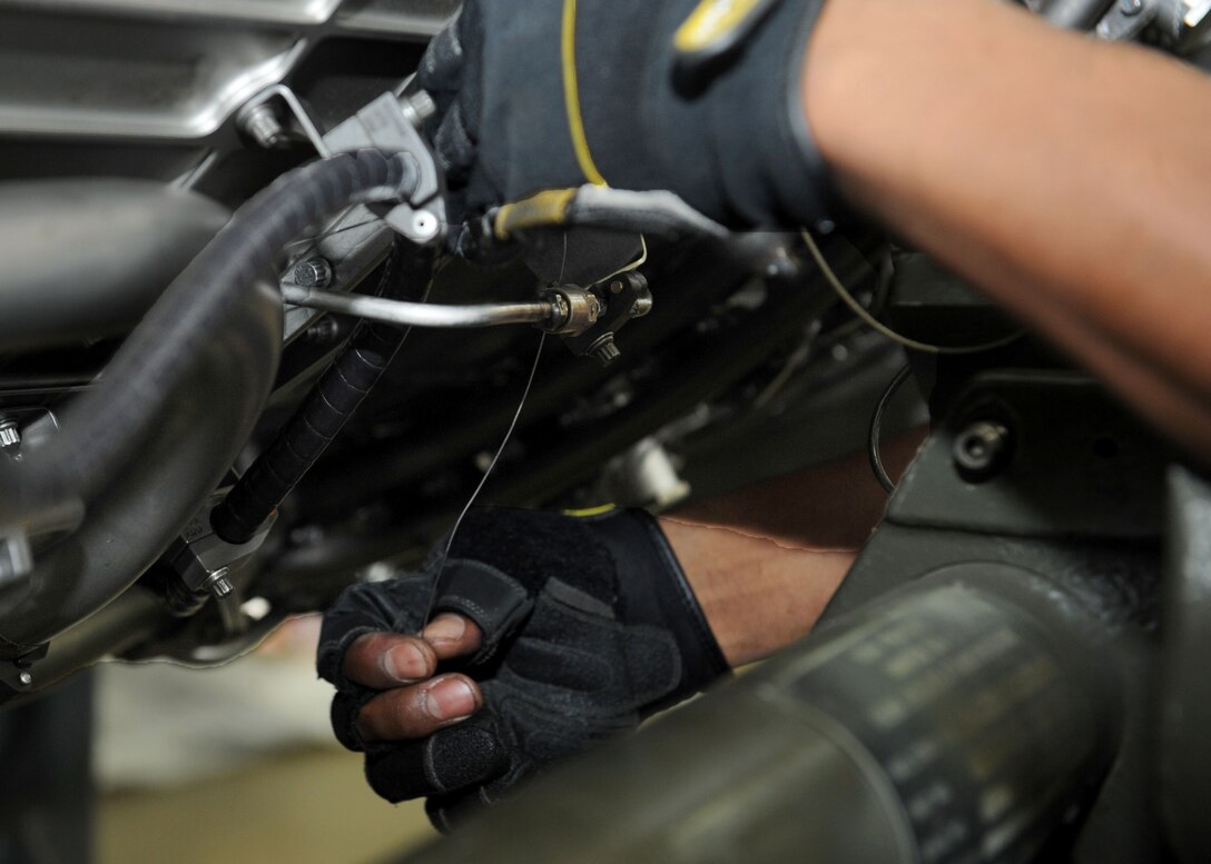 Senior Airman Kymric Walker, 28th Maintenance Squadron aerospace propulsion technician, ties a safety wire onto a B-1 engine during a preposition spare engine inspection in the propulsion back shop at Ellsworth Air Force Base, S.D., Oct. 17, 2013. Propulsion Airmen perform maintenance and repairs to ensure the efficiency and functionality of engines before they are installed into a B-1. (U.S. Air Force photo by Airman 1st Class Rebecca Imwalle/ Released)