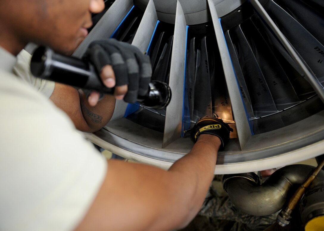 Senior Airman Kymric Walker, 28th Maintenance Squadron aerospace propulsion technician, inspects the fan blades of a B-1 engine during a preposition spare engine inspection in the propulsion back shop at Ellsworth Air Force Base, S.D., Oct. 17, 2013. The Airmen of the propulsion back shop inspect more than 10 B-1 engines per month, ensuring they are mission ready and available when needed. (U.S. Air Force photo by Airman 1st Class Rebecca Imwalle/ Released)