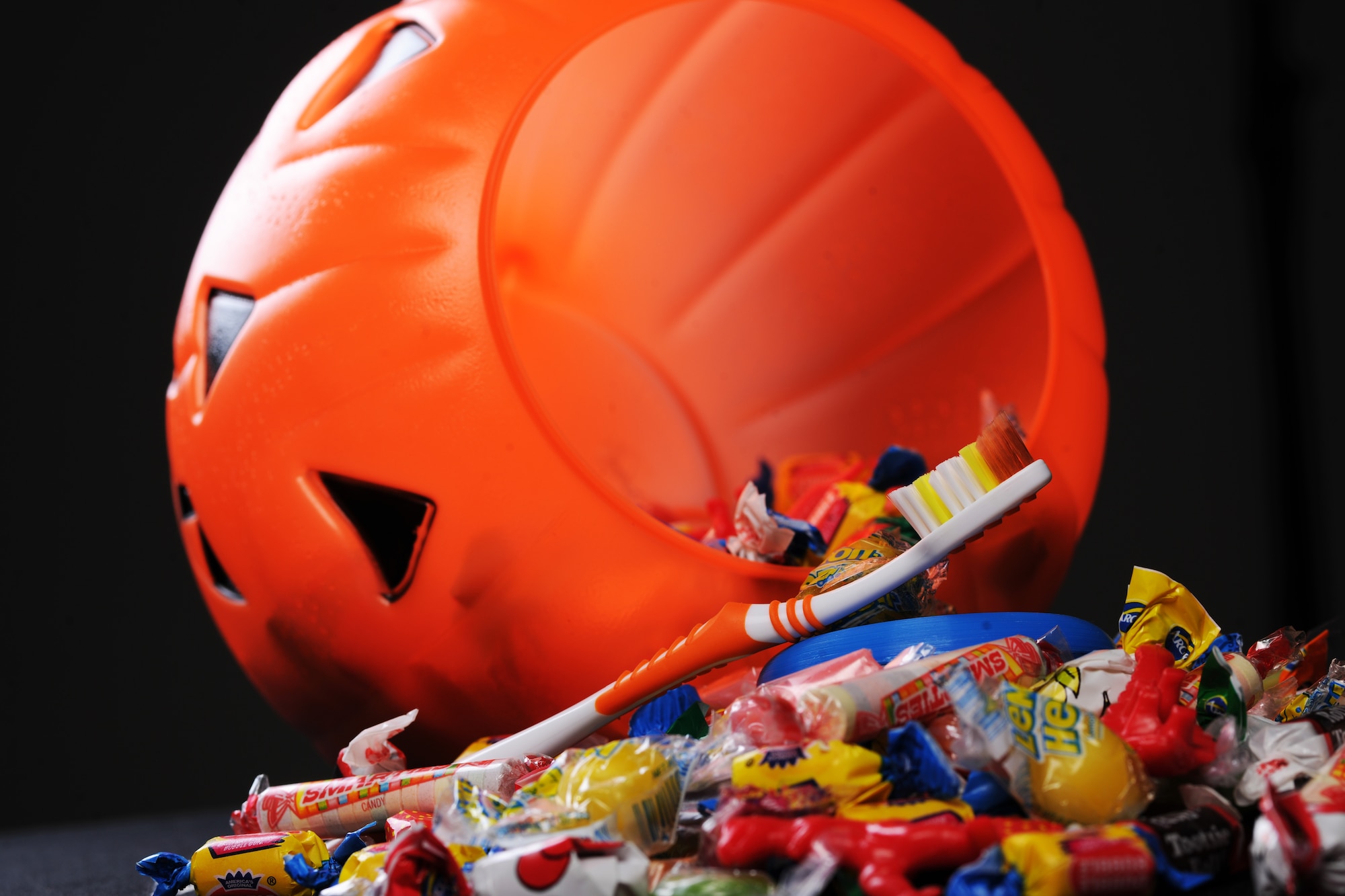 The 99th Dental Squadron is encouraging Airmen and their family members to develop an oral hygiene plan when eating candy during Halloween in order to prevent cavities. For cavities to form, four specific factors must be present concurrently: a susceptible tooth surface, cavity-forming bacteria, sugar and time. (U.S. Air Force photo illustration by Airman 1st Class Jason Couillard)
