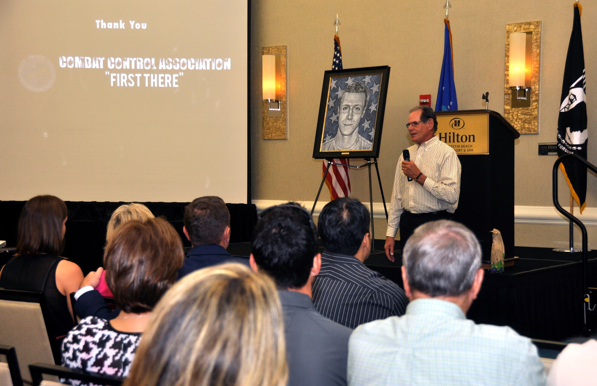 Peter Servais speaks about his son, Senior Airman Adam Servais, after receiving a portrait in his memory Oct. 19, 2013, in Destin, Fla. Servais, a 23rd Special Tactics Squadron combat controller, was killed in action Aug. 19, 2006 while deployed to Afghanistan. (U.S. Air Force photo by Capt. Victoria Porto)