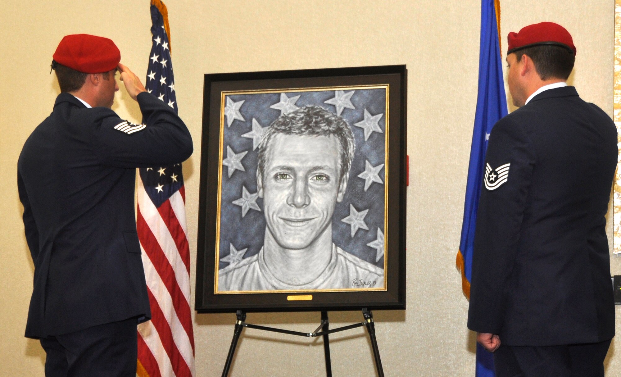 Combat controllers salute the portrait of Senior Airman Adam Servais during a presentation Oct. 19, 2013, in Destin, Fla. Servais, a 23rd Special Tactics Squadron combat controller, was killed in action Aug. 19, 2006 while deployed to Afghanistan. (U.S. Air Force photo by Capt. Victoria Porto)