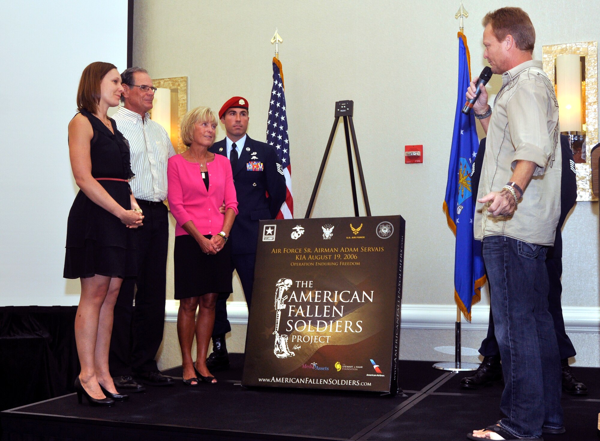 Artist Phil Taylor speaks to the family of Senior Airman Adam Servais before presenting the portrait honoring his service Oct. 19, 2013, in Destin, Fla. Servais, a 23rd Special Tactics Squadron combat controller, was killed in action Aug. 19, 2006 while deployed to Afghanistan. (U.S. Air Force photo by Capt. Victoria Porto)