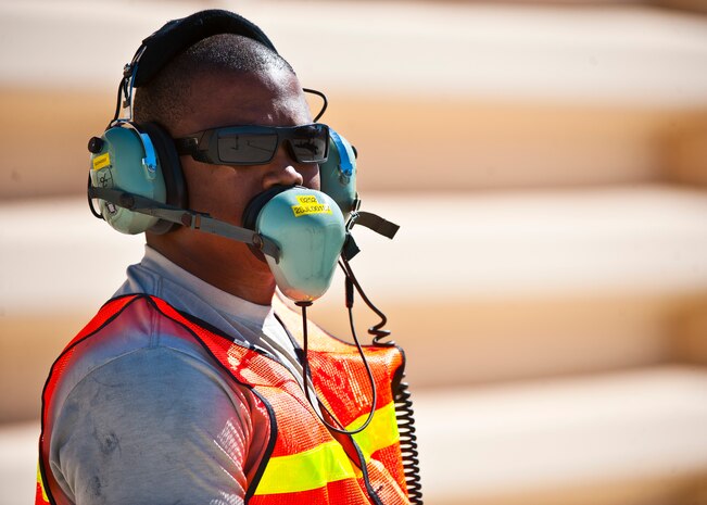 Tech. Sgt. Jermaine Lee, 57th Aircraft Maintenance Squadron aerospace propulsion specialist, communicates via headset to a pilot inside an F-35 Lightning II at the revetments Oct. 16, 2013, at Nellis Air Force Base, Nev. Refueling specialists and crew chiefs assigned to the 57th AMXS and 99th Logistics Readiness Squadron practice this procedure to keep their skills sharp and aid in the effort to provide combat-ready air power at a moment’s notice. (U.S. Air Force photo by Senior Airman Brett Clashman)