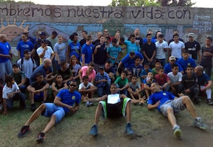 Members of Joint Task Force-Bravo's Army Forces (ARFOR) Battalion pose with children from the Horizontes al Futuro orphanage and school in Comayagua, Honduras, Oct. 20, 2013.  Members of the ARFOR spent the afternoon visiting and playing games with the children from the orphanage and school.  (U.S. Air Force photo by Master Sgt. Young Phung)  