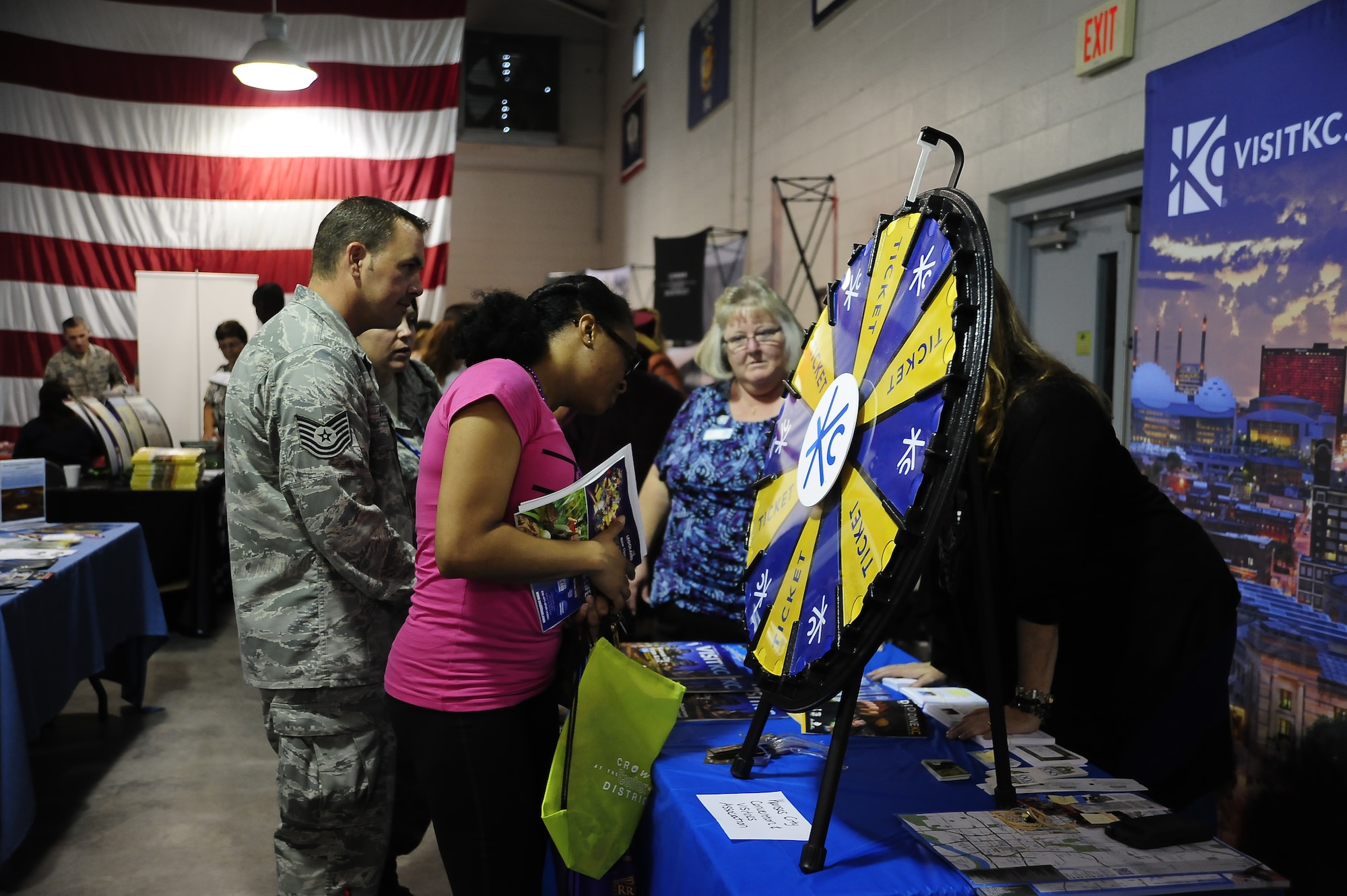 Airmen peruse one of the 65 booths during the Community Fair and Wingman Day Oct. 10, 2013, at Whiteman Air Force Base, Mo. In addition to dozens of off-base organizations highlighting what they have to offer, several on-base organizations also showcased their programs. (U.S. Air Force photo by Staff Sgt. Brigitte N. Brantley/Released)