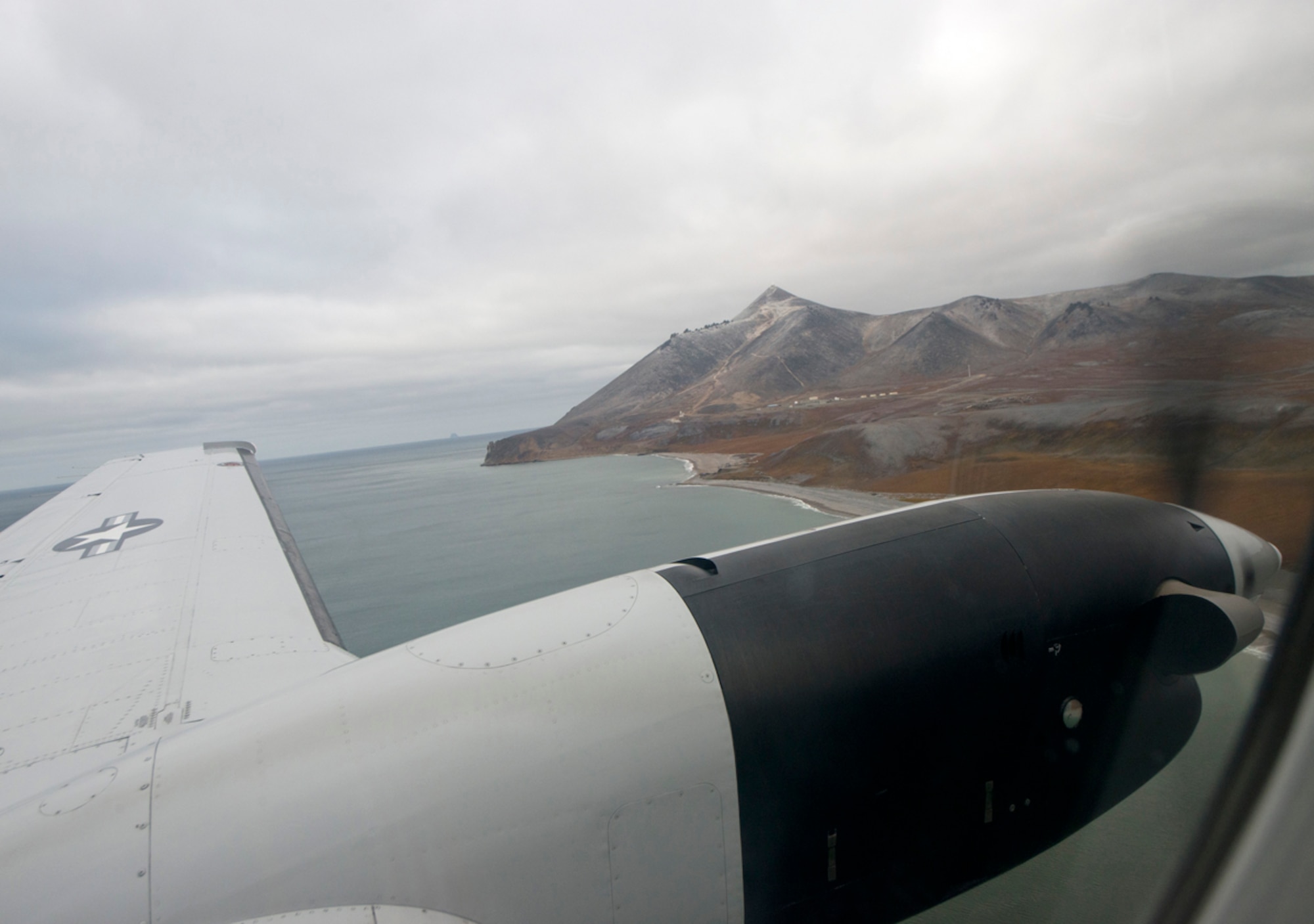 Tin City, a long range radar site, is seen beyond one of the propeller engines as the C-12F Huron prepares to land Sept. 19, 2013. he C-12 took a group from the 611th Air Support Squadron to a long range radar site called Tin City. (U.S. Air Force photo/Staff Sgt. Zachary Wolf) 