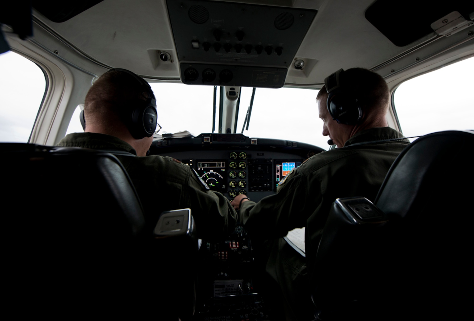 Air Force majors Christopher Paulhamus, 3rd Operations Group chief of standards and evaluations and Blake Johnson, 517th Airlift Squadron C-12F Huron pilot, fly towards a remote long range radar site Sept. 19, 2013. The pilots were taking a group from the 611th Air Support Squadron to check out the radar site known as Tin City. (U.S. Air Force photo/Staff Sgt. Zachary Wolf) 