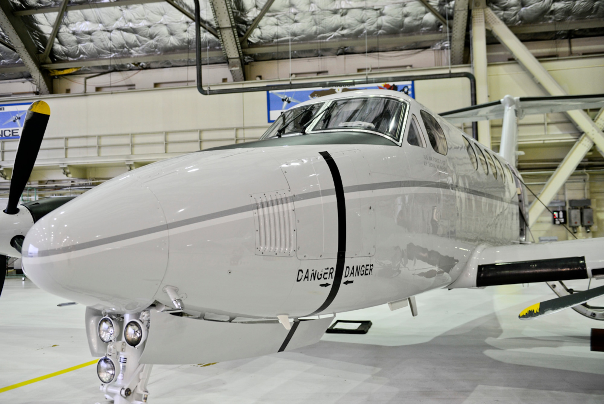 A C-12F Huron sits in a hangar while the pilots prepare to do their preflight checks on Joint Base Elmendorf-Richardson, Sept. 19, 2013. The C-12 took a group from the 611th Air Support Squadron to a long range radar site called Tin City. (U.S. Air Force photo/Staff Sgt. Zachary Wolf) 