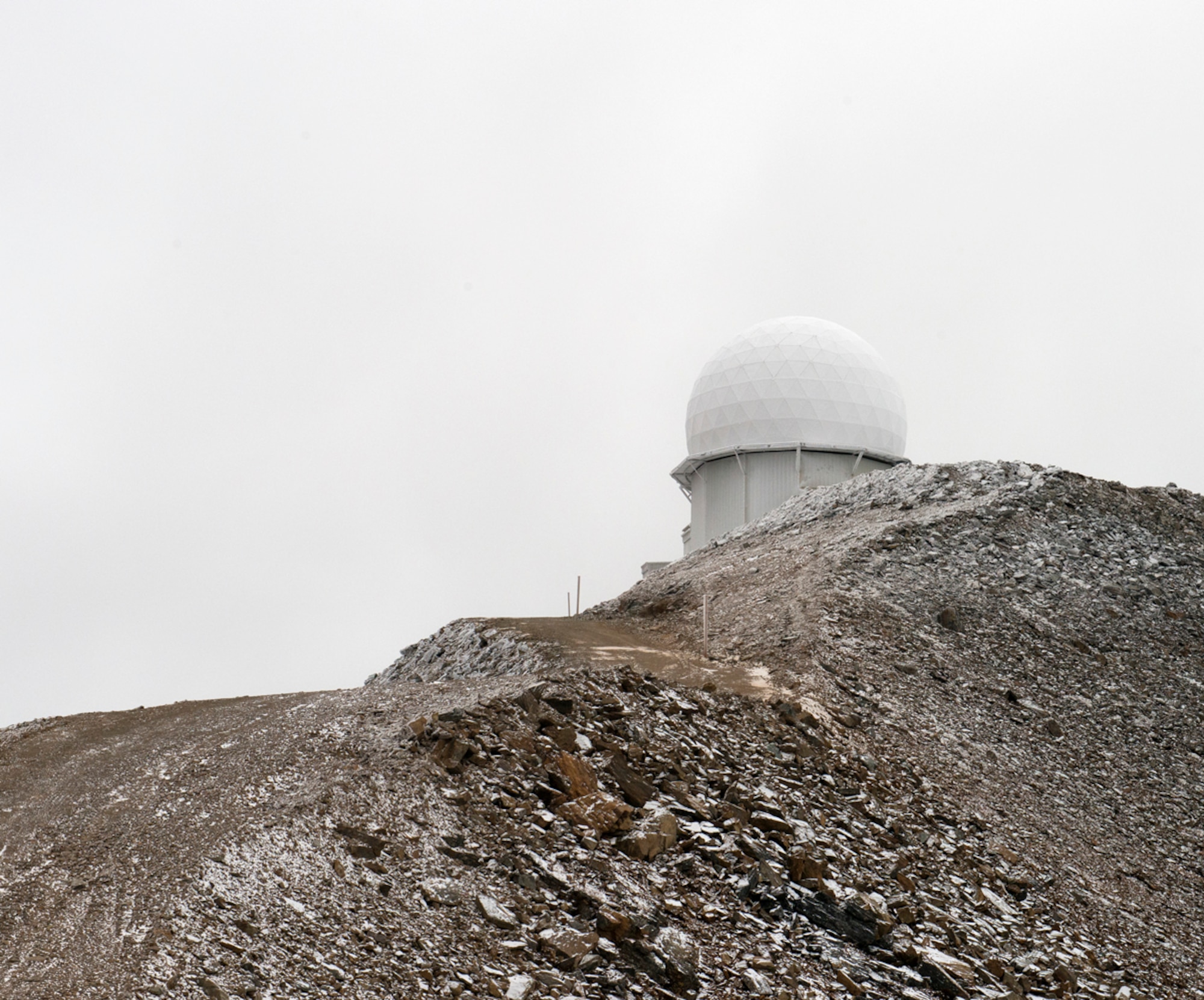 Tin City is one of Alaska's long-range radar sites. The radar can be seen here atop a mountain Sept. 19, 2013. A group from the 611th Air Support Squadron traveled to Tin City on a C-12 and did their quality checks at the site. The C-12 mission helps the radar mission function by providing transportation for personnel and cargo. (U.S. Air Force photo/Staff Sgt. Zachary Wolf) 