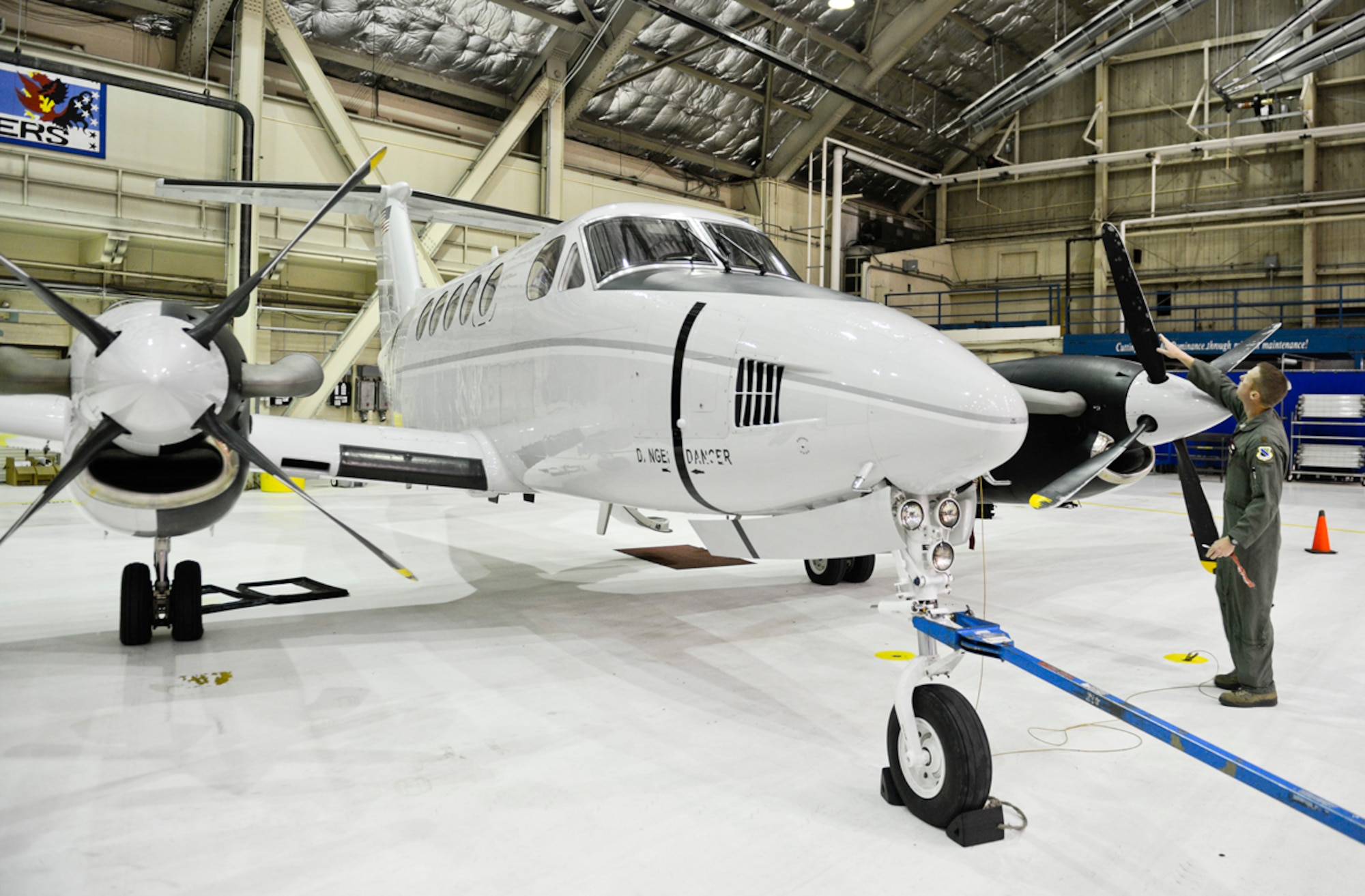Air Force Maj. Blake Johnson, 517th Airlift Squadron C-12F Huron pilot, inspects the propeller blades on the C-12 before takeoff, Sept. 19, 2013. The C-12 was taking took members of the 611th Air Support Squadron to a remote long range radar site called Tin City. (U.S. Air Force photo/Staff Sgt. Zachary Wolf)