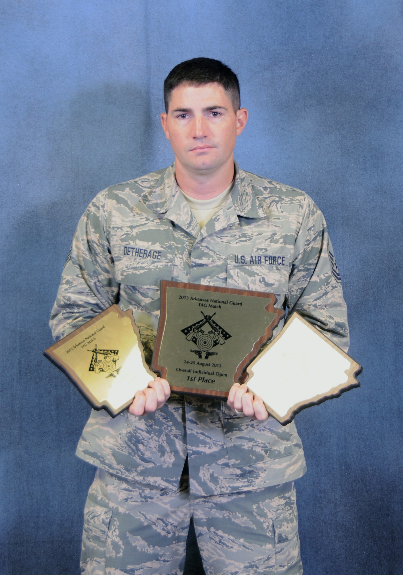 Master Sgt. Brian Detherage of the 188th Security Forces Squadron holds his three individual trophies from the 2013 Arkansas Adjutant General's Marksmanship Exercise held at the National Guard Marksmanship Training Center at Camp Joseph T. Robinson, Ark. Detherage placed first in Individual Overall Rifle/Pistol, Excellence In Competition Rifle and Excellence In Competition Pistol. Additionally, he was a member of the first place Overall Team and Overall Pistol winning teams. (U.S. Air National Guard photo by Senior Airman John Hillier/188th Fighter Wing Public Affairs)