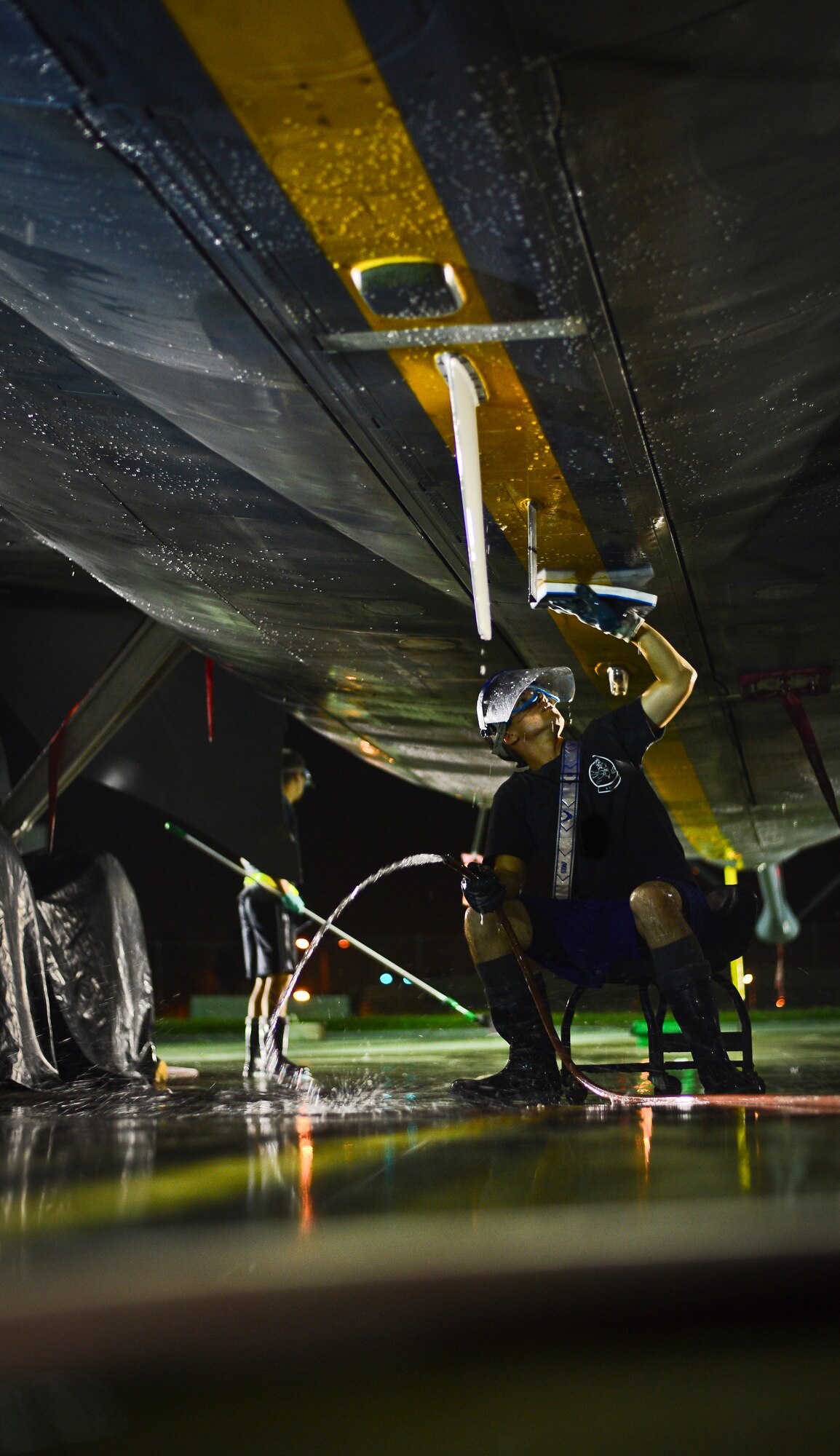 Senior Airman Benjamin Pourian, 6th Aircraft Maintenance Squadron aerospace maintenance technician, inspects the bottom of a KC-135 Stratotanker during an aircraft wash, MacDill Air Force Base, Fla., Oct. 16, 2013. MacDill’s KC-135s are washed every 30 days to prevent salt water corrosion. (U.S. Air Force photo by Staff Sgt. Brandon Shapiro /Released)