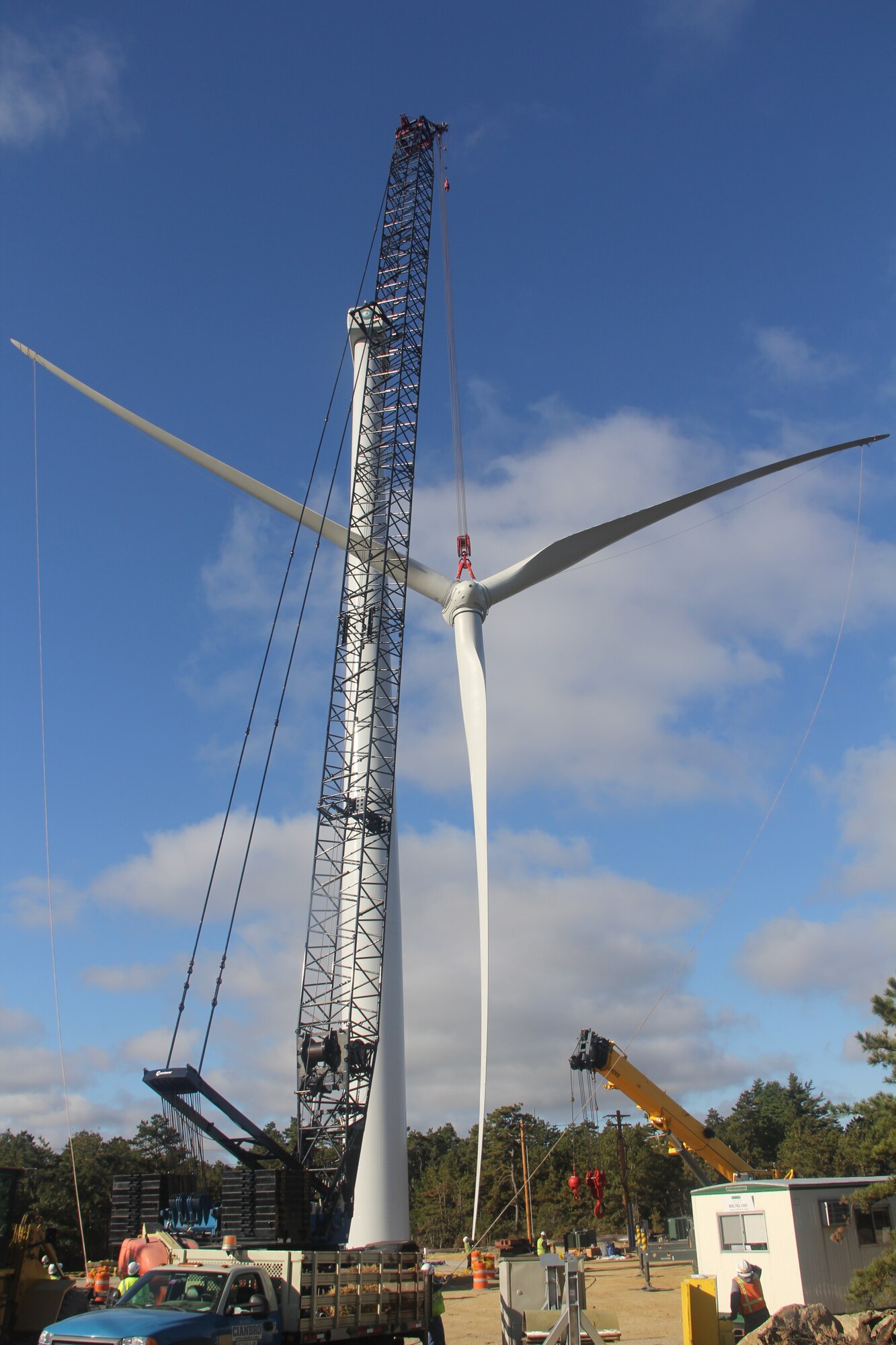 CAPE COD AIR FORCE STATION, Mass. – The turbine’s blade assembly is hoisted into place atop the 260-foot tall tower. The two turbines can together produce up to 3.2 megawatts of power putting the 21st Space Wing in line with the Air Force's goal of using 25 percent renewable energy by 2025. (U.S. Air Force photo)