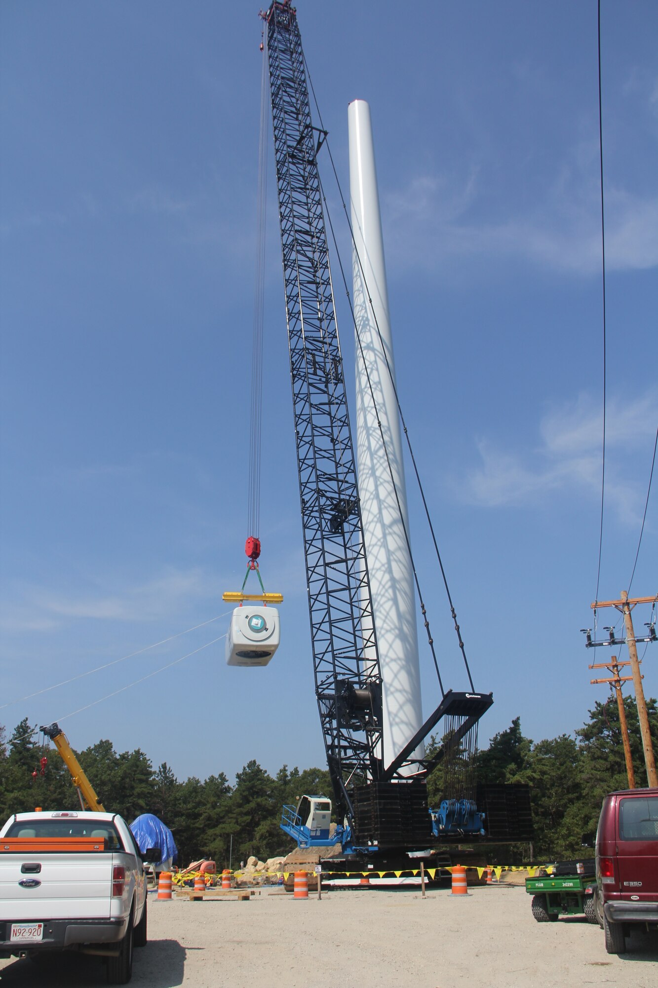 CAPE COD AIR FORCE STATION, Mass. – The nacelle is lifted into place 260 feet atop the wind turbine tower near the 6th Space Warning Squadron. The turbines will put the 21st Space Wing in line with the Air Force's goal of using 25 percent renewable energy by 2025. (U.S. Air Force photo)
