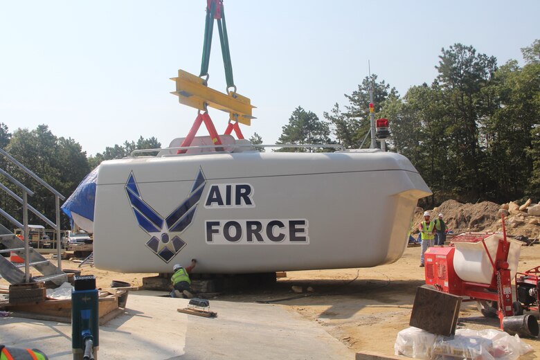 CAPE COD AIR FORCE STATION, Mass. – Workers position the wind turbine nacelle before it is lifted into place at Cape Cod Air Force Station. The nacelle weighs more than 125,000 pounds and will produce up to 3.2 megawatts of power putting the 21st Space Wing in line with the Air Force's goal of using 25 percent renewable energy by 2025. (U.S. Air Force photo)