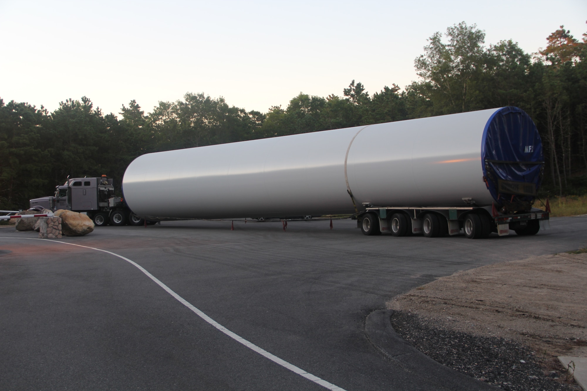 CAPE COD AIR FORCE STATION, Mass. – A truck arrives at the 6th Space Warning Squadron carrying one piece of a wind turbine tower. The massive tower arrived in three pieces, ranging from 72- to 97-feet long. The new wind turbines can together produce up to 3.2 megawatts of power and put the 21st Space Wing in line with the Air Force's goal of using 25 percent renewable energy by 2025. (U.S. Air Force photo)