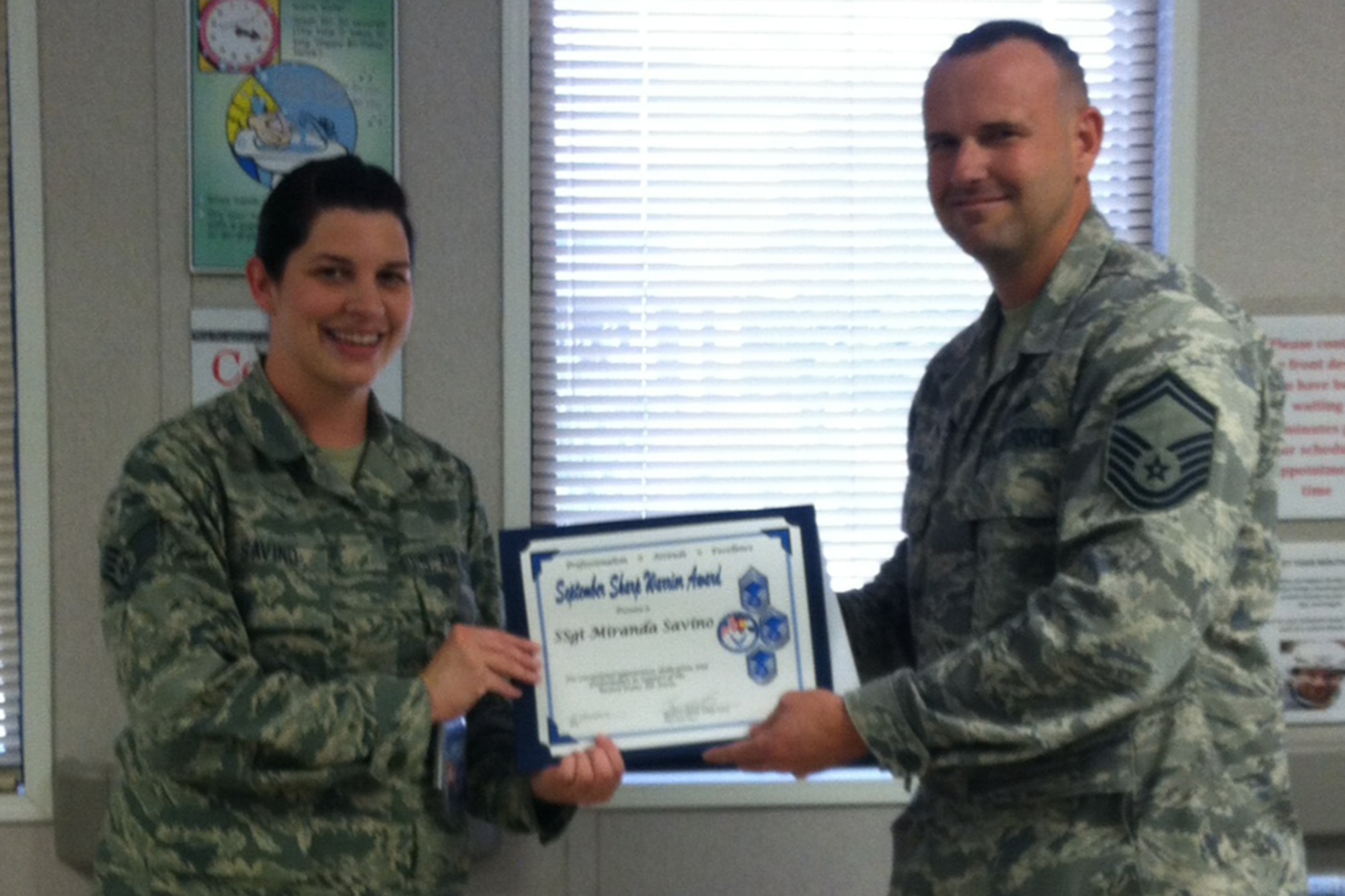 PETERSON AIR FORCE BASE, Colo. – Senior Master Sgt. Brian Smith, on behalf of the Pikes Peak Top 3, presents the September 2013 Sharp Warrior Award to Staff Sgt. Miranda Savino, 21st Dental Squadron. In addition to her primary duties, Savino spearheaded the re-establishment of a remote dental clinic at the Cheyenne Mountain Air Force Station aide station. She identified an infection control issue, researched options after duty hours, presented solutions to senior leadership, and executed the solution flawlessly. Savino's dedication and professionalism led to her selection as the Sharp Warrior. (U.S. Air Force photo)