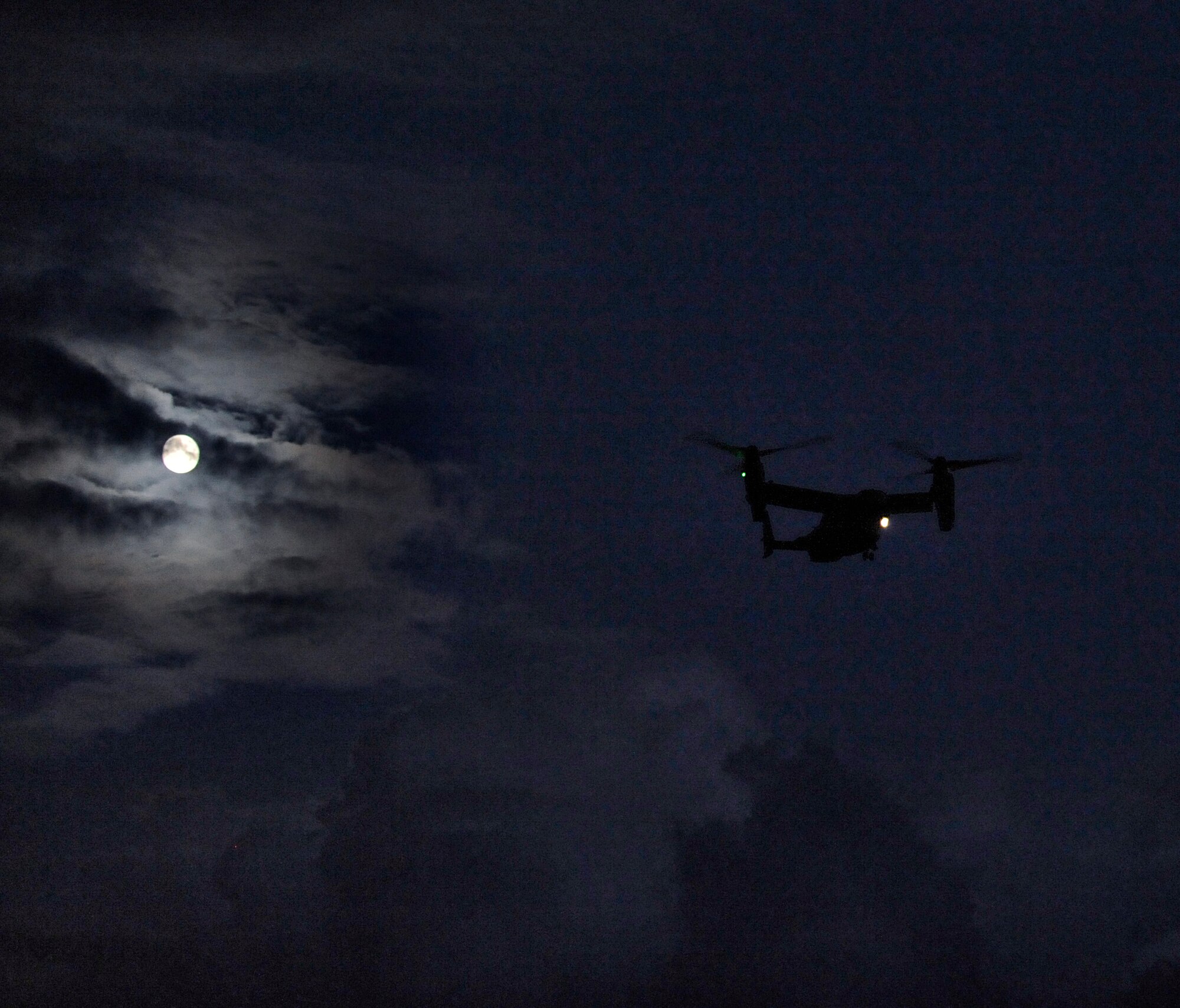 A CV-22 Osprey flies over the Santa Rosa Sound to pick up two pararescuemen Oct. 17, 2013. The pararescuemen, from the 23rd Special Tactics Squadron, were being picked up as part of a night training exercise. (U.S. Air Force photo/Staff Sgt. Jeff Andrejcik)