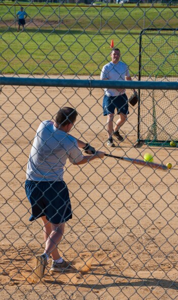 U.S. Air Force Tech Sgt. Chris Gibbons,723rd Aircraft Maintenance Squadron NCO in charge of program integration office, hits a softball during Super Sports Day at Moody Air Force Base, Ga., Oct. 18, 2013. Gibbons competed in the homerun derby where his goal was to try to hit the most homeruns. (U.S. Air Force photo by Airman 1st Class Alexis Grotz/Released)