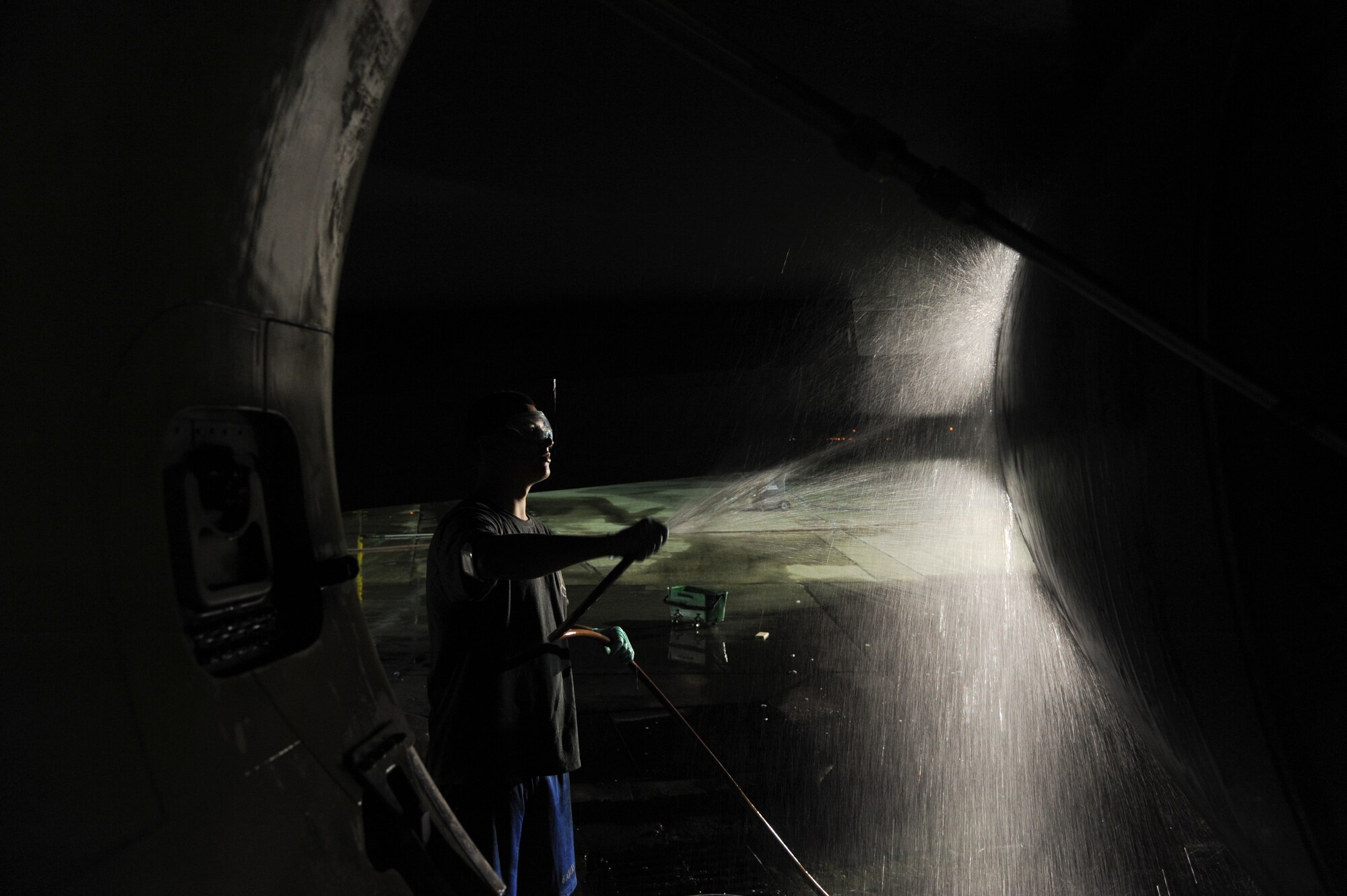 Airman 1st Class Jacob Hansink, 6th Aircraft Maintenance Squadron aerospace propulsion technician, rinses off a KC-135 Stratotanker at MacDill Air Force Base, Fla., Oct. 16, 2013. It took Hansink and eight other Airmen more than four hours to wash the jet. (U.S. Air Force photo by Airman 1st Class Ned T. Johnston/Released)