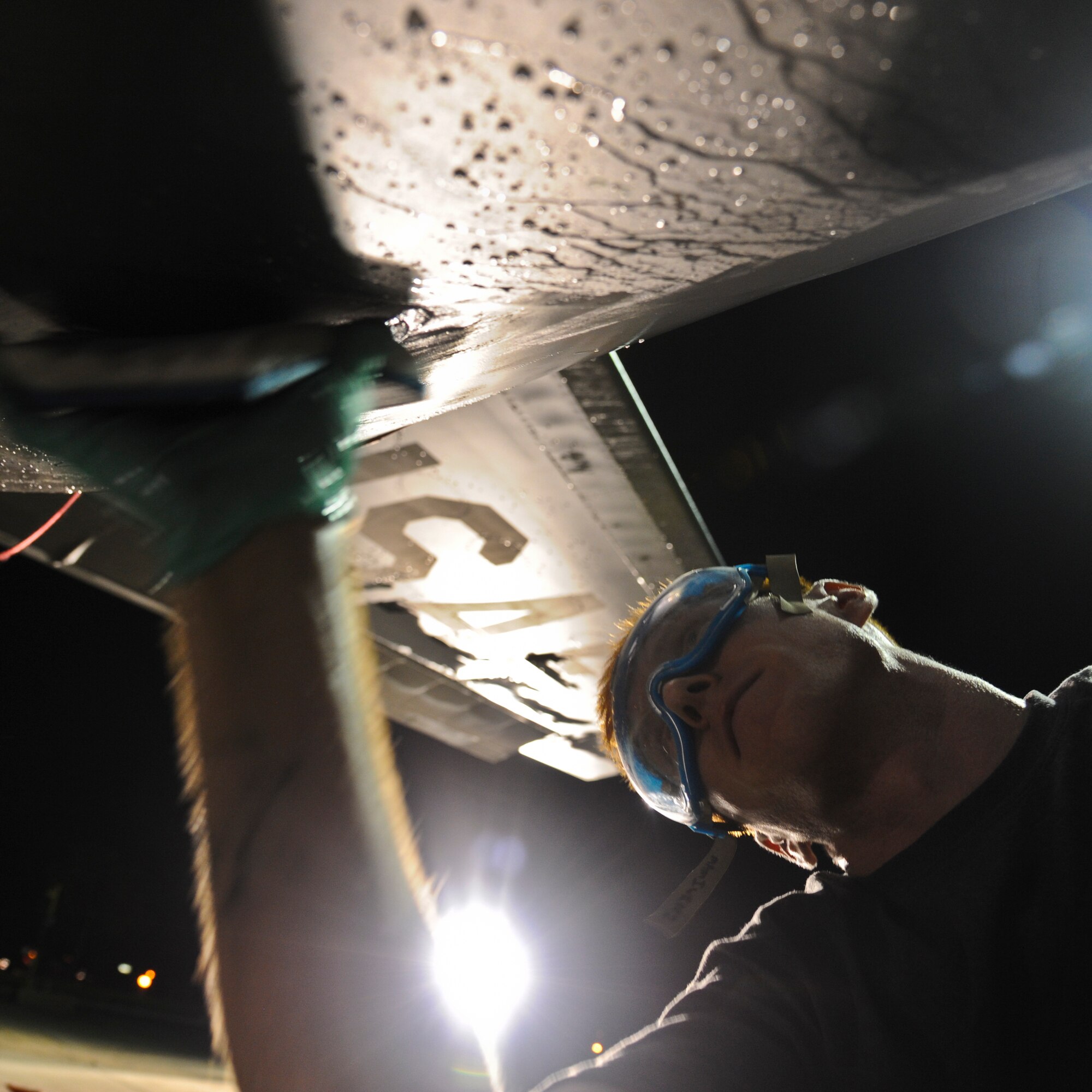 Senior Airman Joseph Rea, 6th Aircraft Maintenance Squadron aerospace guidance and control systems technician, washes a KC-135 Stratotanker at MacDill Air Force Base, Fla., Oct. 16, 2013. The massive, 136-foot jet took more than four hours to wash by hand. (U.S. Air Force photo by Airman 1st Class Ned T. Johnston/Released)