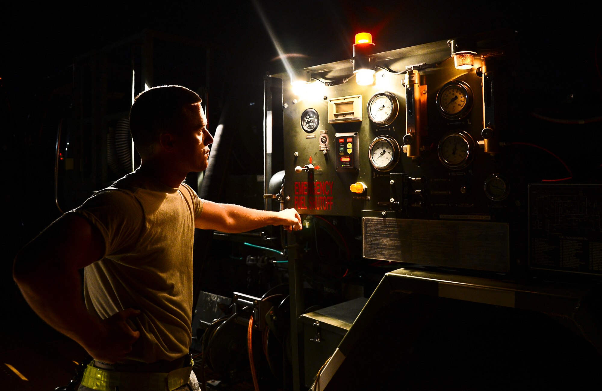 Airman 1st Class Caleb Cano, 6th Logistics Readiness Squadron refueling unit operator, monitors the gages on an R-11 fuel vehicle during a refueling of a KC-135 Stratotanker, Oct. 10, 2013 at MacDill Air Force Base, Fla. The KC-135 can hold up to 200,000 lbs. of fuel and can double as a medical evacuation aircraft. (U.S. Air Force photo by Senior Airman Melanie Bulow-Kelly/Released)