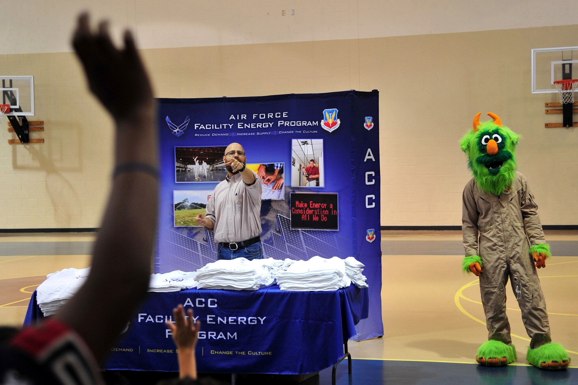 Matthew Latham, 4th Civil Engineer Squadron installation energy manager and Airman e-BEAST, 4th CES energy awareness mascot, ask children questions during an Energy Action Month event at Seymour Johnson Air Force Base, N.C., Oct. 16, 2013. This year’s Energy Action Month theme is "I am Air Force Energy," recognizing the role each member of Team Seymour plays in helping the Air Force achieve its energy goals. (U.S. Air Force photo by Senior Airman Mariah Tolbert)
