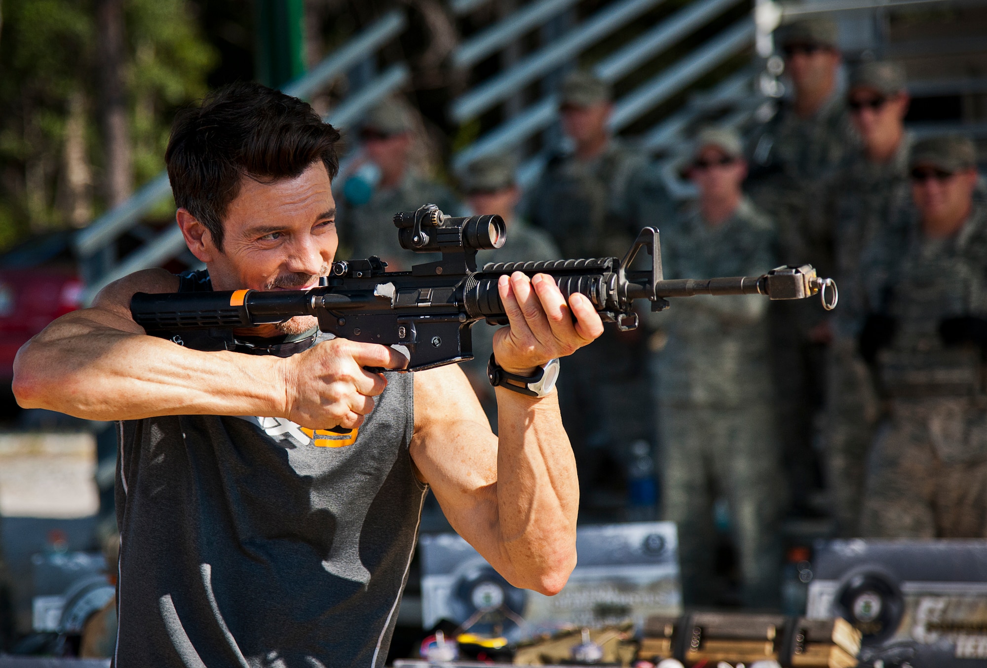 Fitness expert, Tony Horton, takes aim with an M-4 rifle during his visit with the Airmen of the 96th Ground Combat Training Squadron Oct. 16 at Eglin Air Force Base, Fla.  The tour was part of Horton’s day-long visit here.  Horton also visited Tyndall AFB and Pensacola Naval Air Station while in the area. (U.S. Air Force photo/Samuel King Jr.)