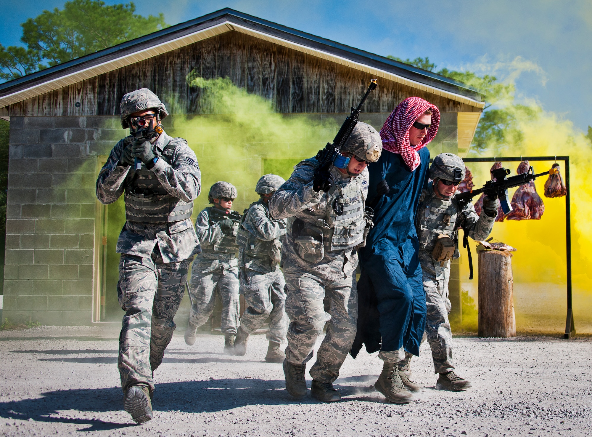 A 96th Ground Combat Training Squadron fire team leads an enemy combatant back to their vehicles during a demonstration exercise Oct. 16 at Eglin Air Force Base, Fla.  Approximately 1,500 active-duty, reserve and National Guard Airmen attend the squadron’s "Brave Defender" training each year.  "Defender" is a six-week deployment training course for security forces Airmen. It is one of only six SF deployment training courses in the U.S. The course opened here in 2002 and was established by Air Force Materiel Command to satisfy security forces training requirements in an expeditionary environment (U.S. Air Force photo/Samuel King Jr.)