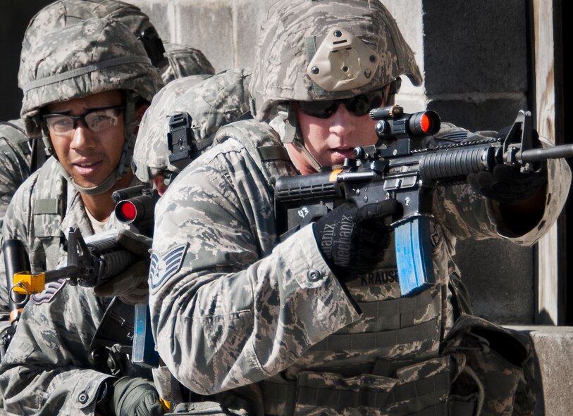 Staff Sgt. Matthew Krause, of the 96th Ground Combat Training Squadron, leads a fire team along a building during a demonstration exercise Oct. 16 at Eglin Air Force Base, Fla.  Approximately 1,500 active-duty, reserve and National Guard Airmen attend the squadron’s "Brave Defender" training each year.  "Defender" is a six-week deployment training course for security forces Airmen. It is one of only six SF deployment training courses in the U.S. The course opened here in 2002 and was established by Air Force Materiel Command to satisfy security forces training requirements in an expeditionary environment (U.S. Air Force photo/Samuel King Jr.) 
