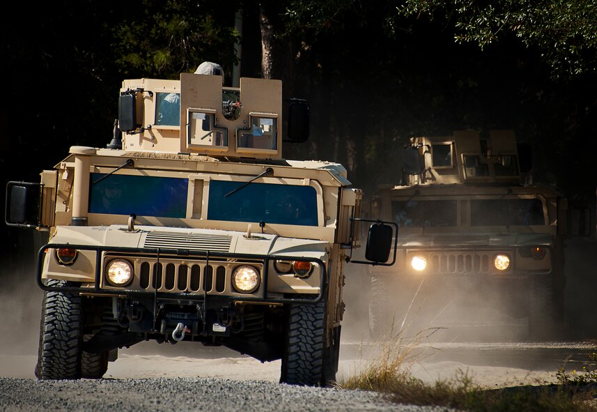 Humvees carrying Airmen from the 96th Ground Combat Training Squadron roll in during a demonstration exercise Oct. 16 at Eglin Air Force Base, Fla.  Approximately 1,500 active-duty, reserve and National Guard Airmen attend the squadron’s "Brave Defender" training each year.  "Defender" is a six-week deployment training course for security forces Airmen. It is one of only six SF deployment training courses in the U.S. The course opened here in 2002 and was established by Air Force Materiel Command to satisfy security forces training requirements in an expeditionary environment (U.S. Air Force photo/Samuel King Jr.)