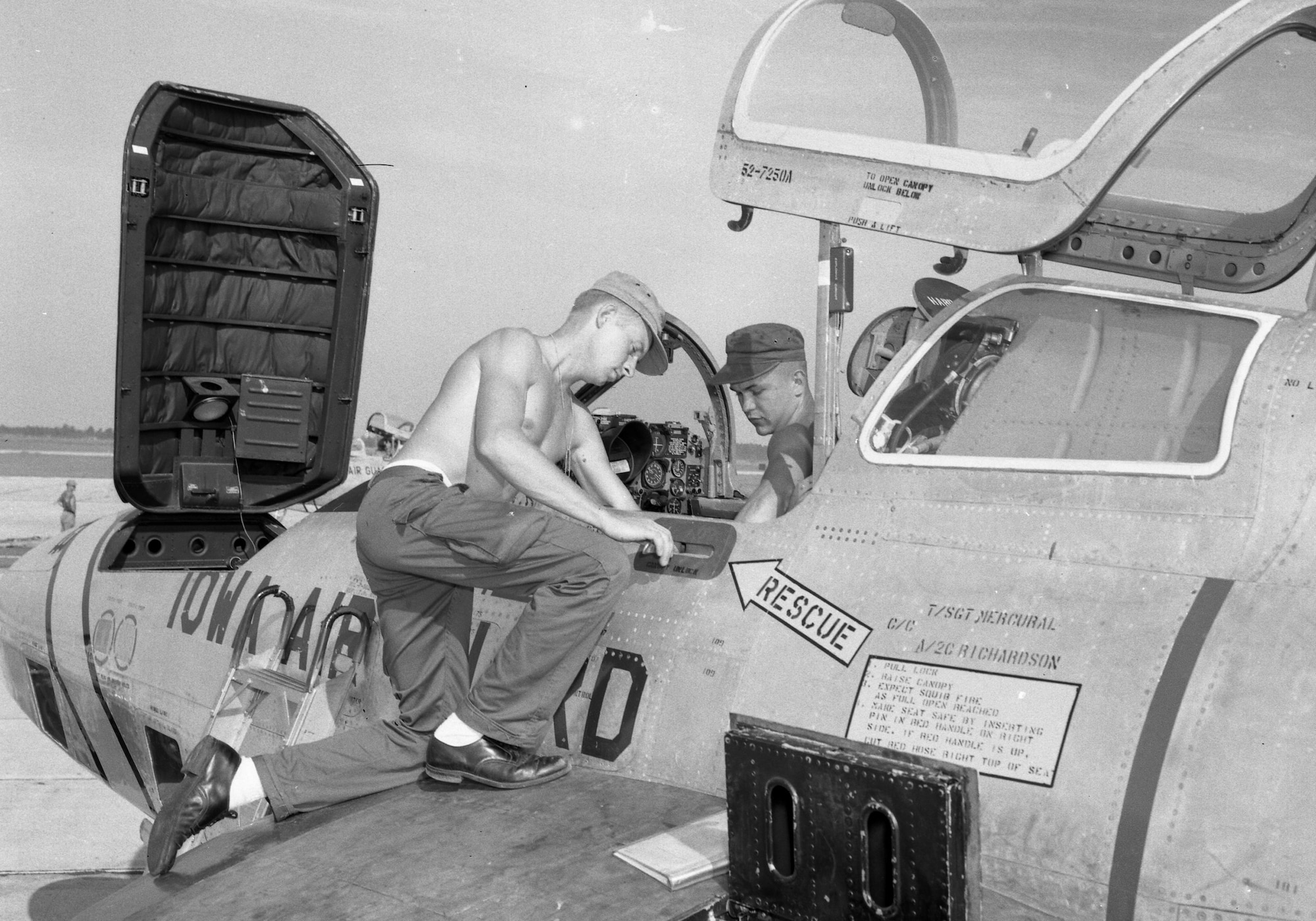 Airman from the 174th Tactical Reconnaissance Squadron performing general operational maintenance on a RF-84 while on the flight line in Sioux City, Iowa during the summer of 1959. The door on the front of the aircraft allowed airman to access a large compartment where photo equipment was installed and used as part of the reconnaissance mission.
Iowa Air Guard Photo