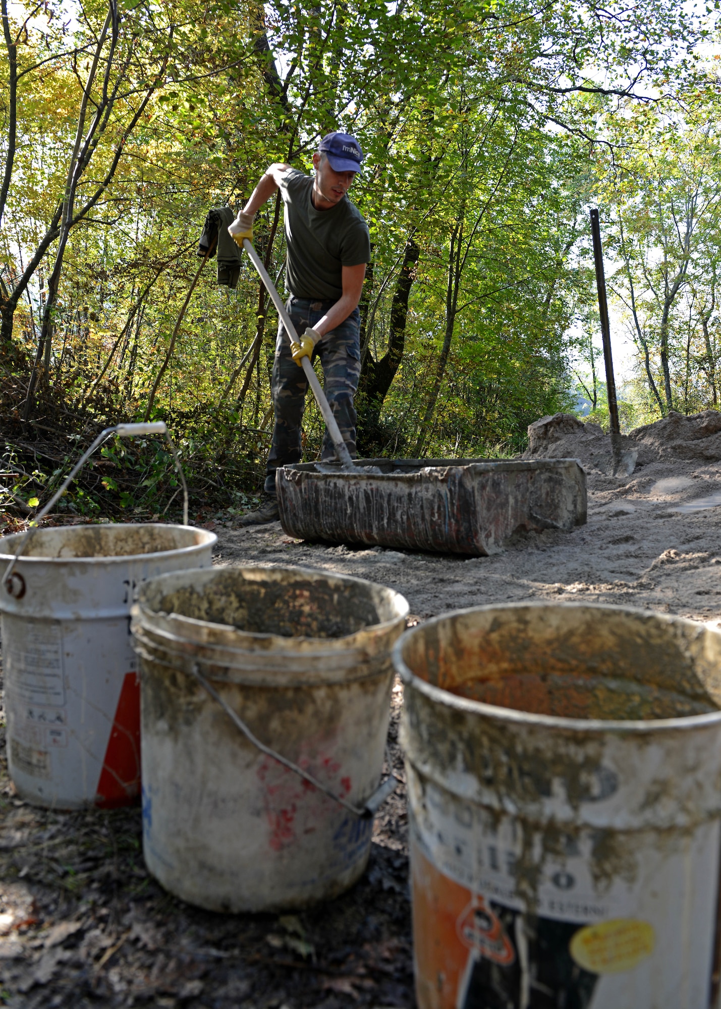 An Italian volunteer mixes concrete that will be used to repair the Ruial Canal Oct. 19, 2013, in Budoia Italy. More than 40 volunteers removed moss and weeds,  cemented new stones, and cut back overgrown vegetation along the 400 year old canal.(U.S. Air Force photo/Staff Sgt. Ryan Whitney)