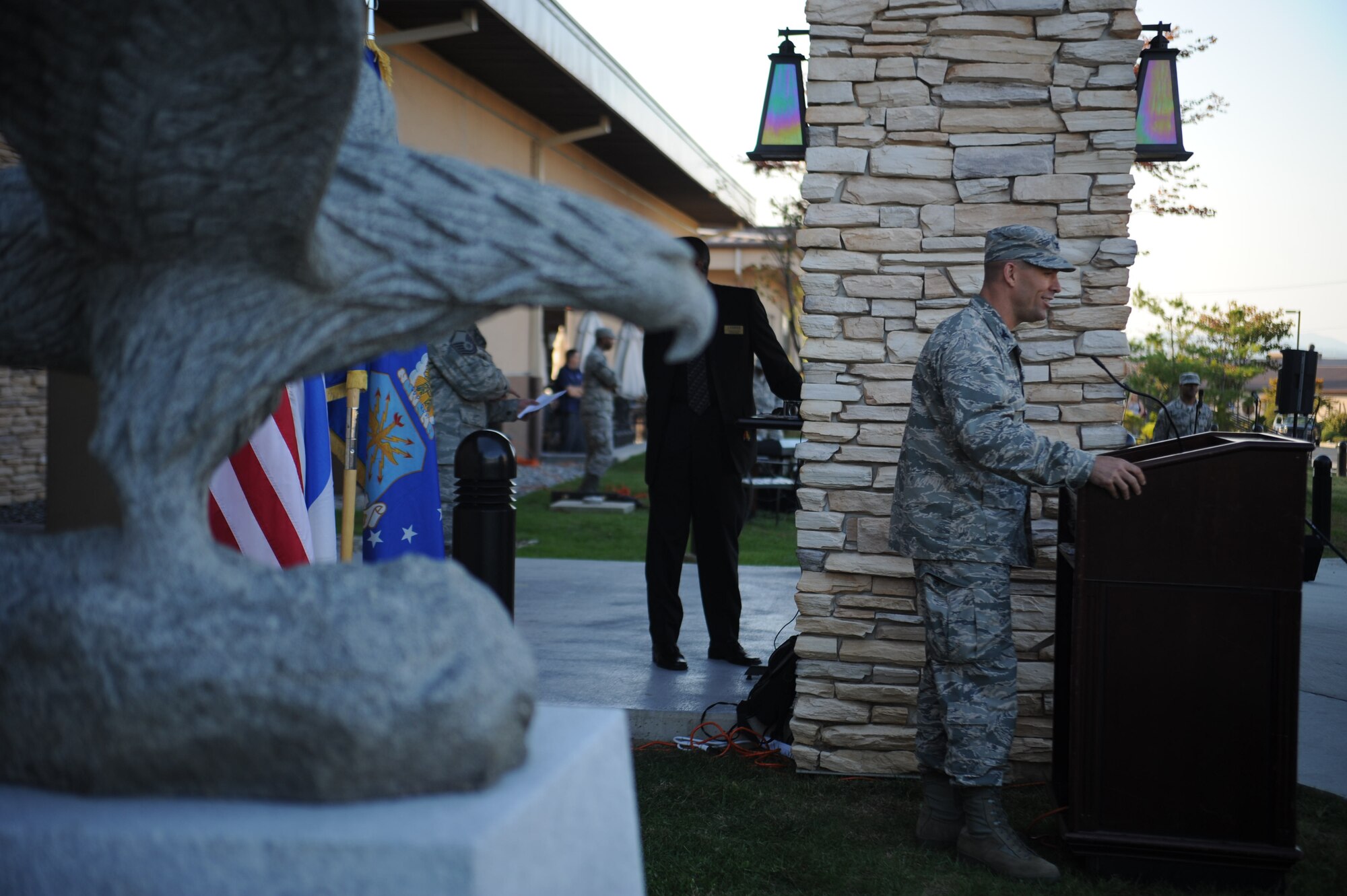 Col. Brook Leonard, 51st Fighter Wing commander, speaks about the importance of U.S. Air Force tradition and heritage after the unveiling of a statue dedicated to retired Master Sgt. Jim Price in front of the Osan Enlisted Club at Osan Air Base, Republic of Korea, Oct. 18, 2013. The ceremony was held to celebrate enlisted heritage and the legacy of Price, who was a Tuskegee Airman and member of the Osan community. (U.S. Air Force photo/Staff Sgt. Sara Csurilla)